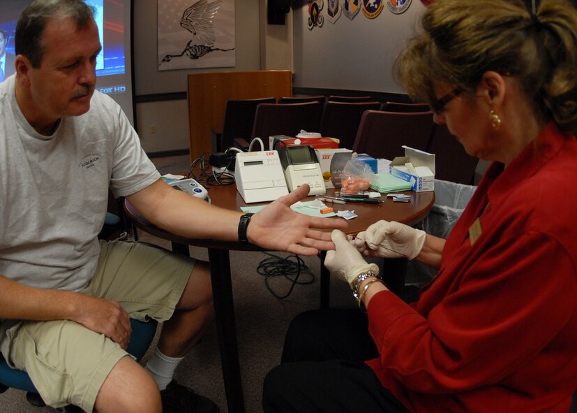 Chester Arrant, 919th Maintenance Squadron, has blood drawn by Marilyn Leggett, 96th Medical Group, as part of a cholesterol and blood pressure screening for civilians Aug. 5 at Duke Field.  The screening is part of the civilian health promotion service to make government civilians aware of their health and provide tips on nutrition, exercise and an active lifestyle.  (U.S. Air Force photo/Staff Sgt. Samuel King Jr.)