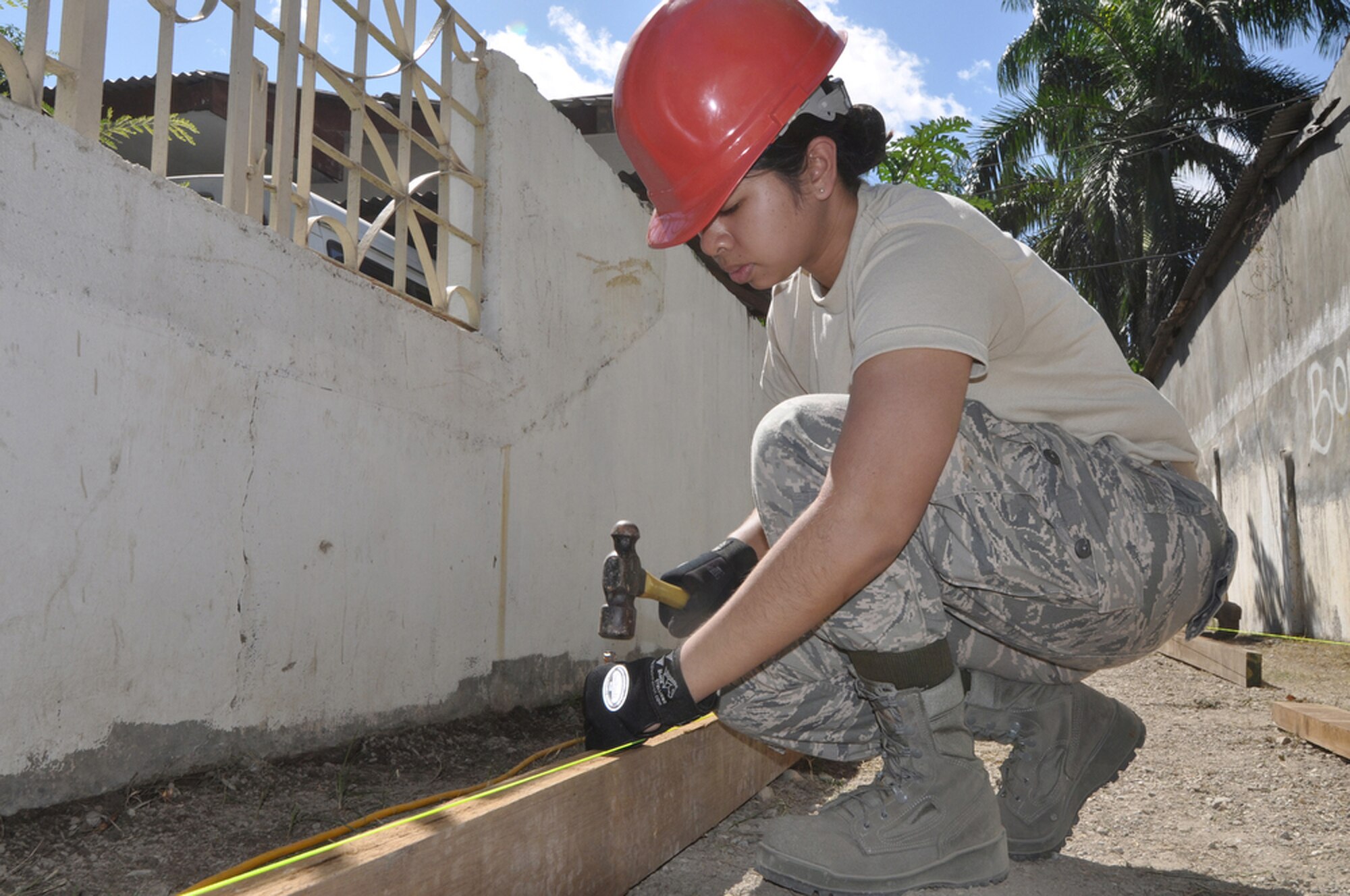 Staff Sgt. Kesha Rosario drives a stake in the ground to fortify a wooden beam that will be used in the foundation of a new sidewalk outside the national hospital July 16 in Dili, Timor Leste. Sergeant Rosario is a knowledge operations management journeyman with the Guam Air National Guard's 254th RED HORSE Squadron at Andersen Air Force Base, Guam. The squadron was in Timor Leste as part of Pacific Angel 2009, a Pacific Air Forces humanitarian assistance operation. (U.S. Air Force photo/Tech. Sgt. Cohen A. Young) 