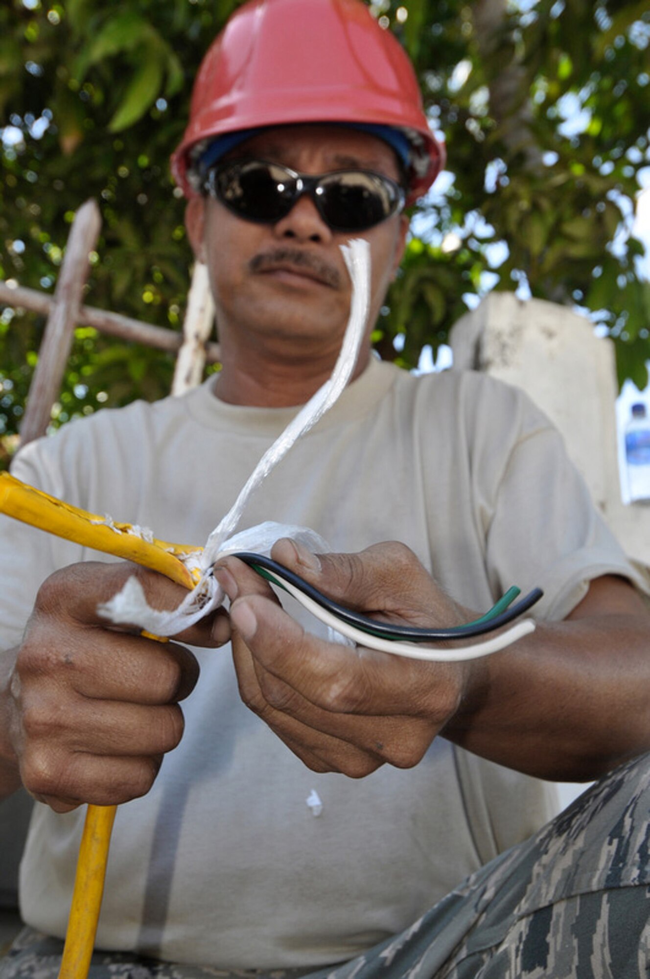 Master Sgt. Mark McAuslem splices a wire so he can divert power to a different area inside the national hospital July 16 in Dili, Timor Leste. Sergeant McAuslem is a member of the Guam Air National Guard's 254th RED HORSE Squadron at Andersen Air Force Base, Guam. The squadron was in Timor Leste as part of Pacific Angel 2009, a Pacific Air Forces humanitarian assistance operation. (U.S. Air Force photo/Tech. Sgt. Cohen A. Young) 

