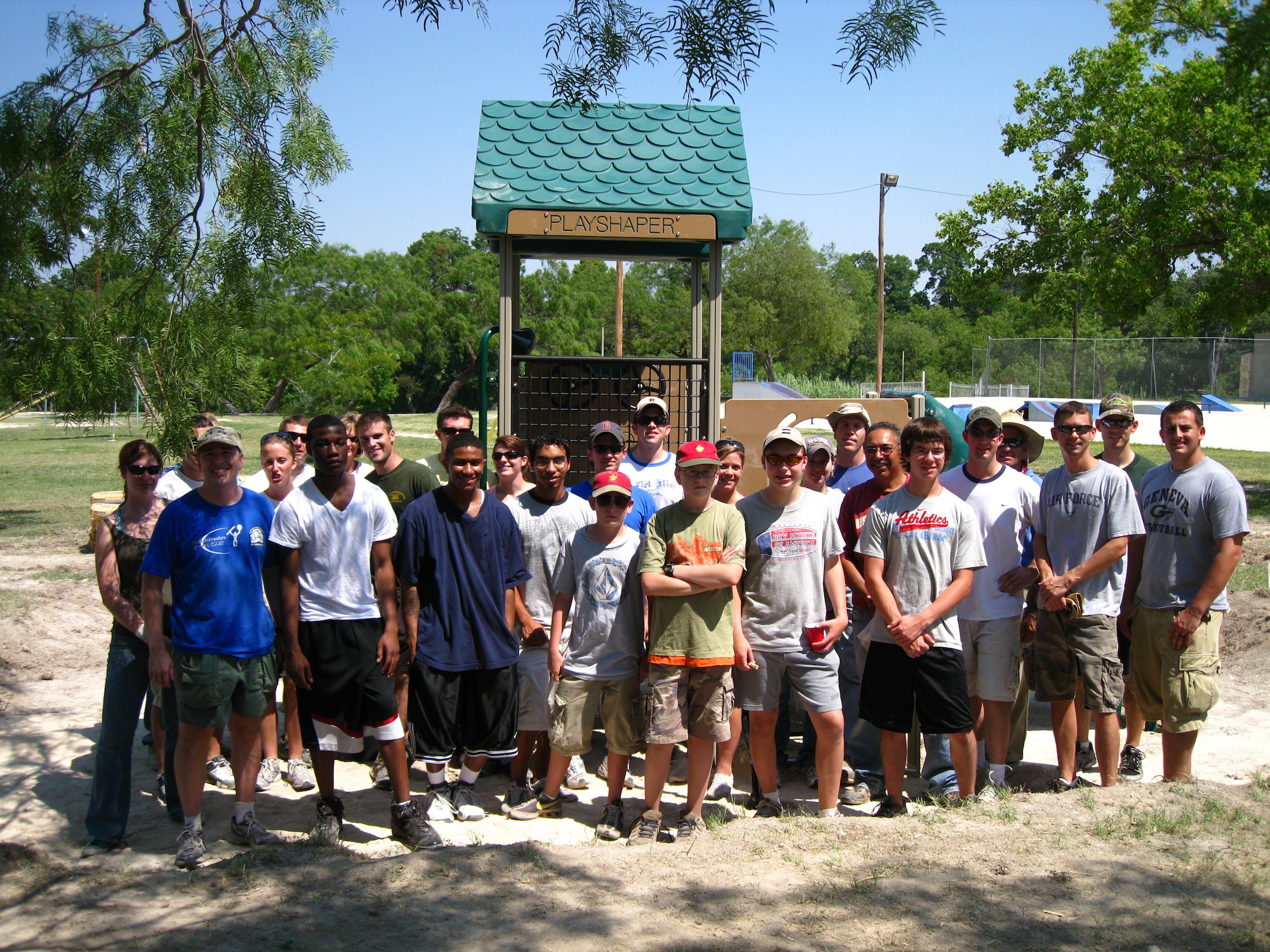 LAUGHLIN AIR FORCE BASE, Texas—Members of the Boy Scouts, Laughlin Air Force Base and the City of Del Rio stand in front of the playground set they built for local children to enjoy June 27.  Daniel Cinnamon and David Garcia, Eagle Scout Candidates and Life Scouts from Troop 280, spearheaded the project and were responsible for organizing the volunteer team and obtaining donations from the local business community. (U.S. Air Force photo by Lt. Col. John Cinnamon)