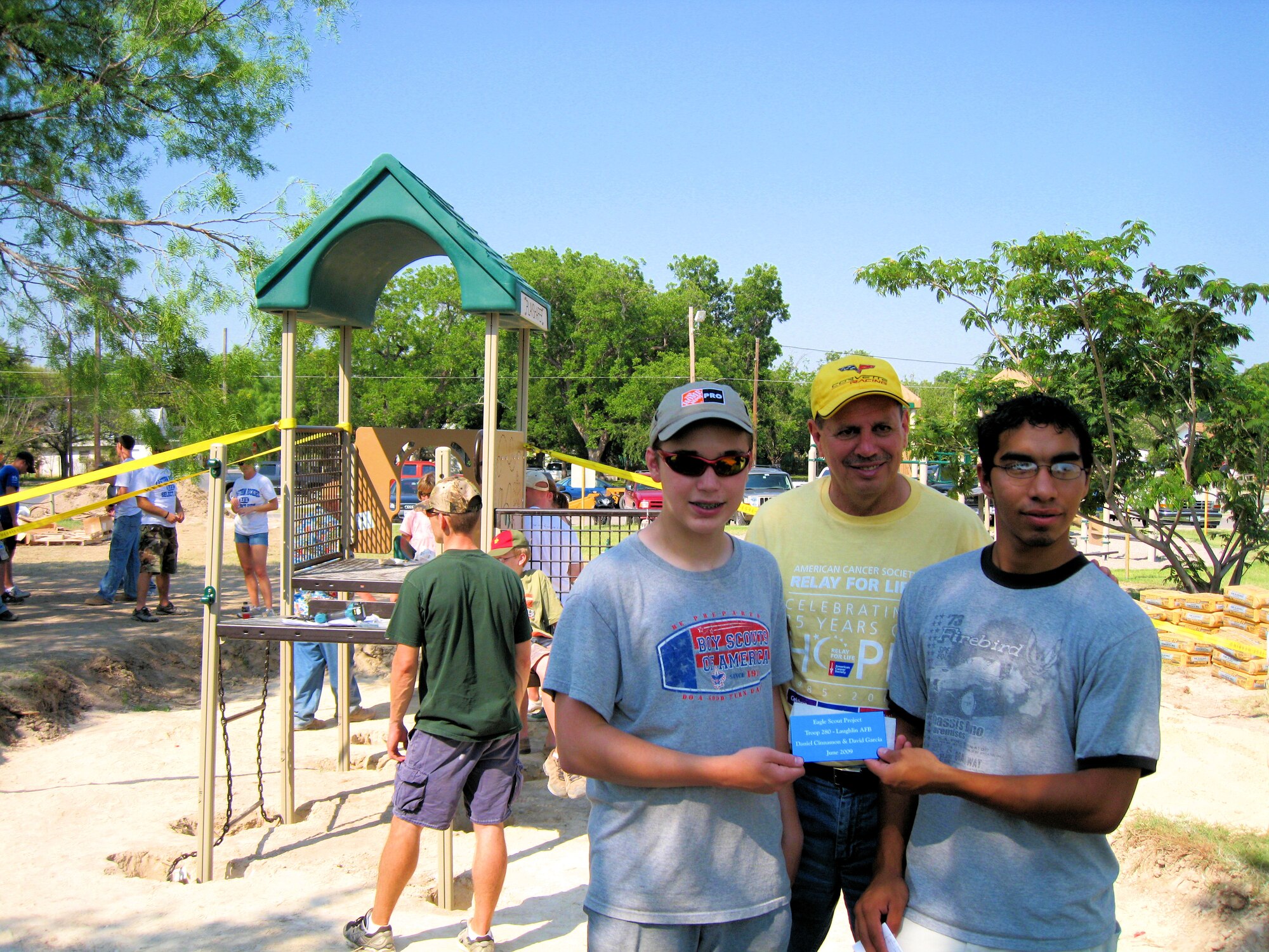 LAUGHLIN AIR FORCE BASE, Texas-- Daniel Cinnamon and David Garcia, Eagle Scout candidates and Life Scouts from Troop 280, meet with Del Rio Mayor Efrain Valdez while building a toddler playground structure for local children to enjoy June 27.  Daniel, son of Lt. Col. John Cinnamon, 86th Flying Training Squadron commander, and David, son of Mr. Jerry Garcia, the Real Property Officer for Laughlin and a member of the 47th Installation Support Squadron, spearheaded the project and were responsible for organizing the volunteer team and obtaining donations from the local business community. (U.S. Air Force photo by Lt. Col. John Cinnamon)