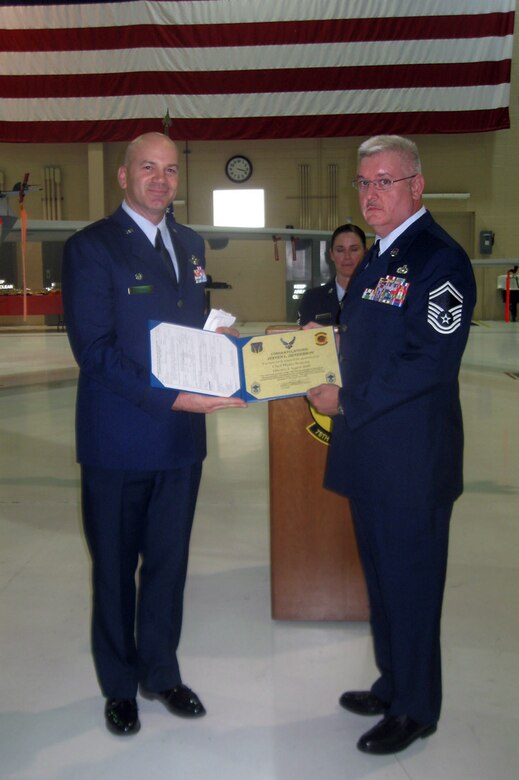 Chief Master Sgt. Steven Henderson, 78th Reconnaissance Squadron superintendent (right), receives his promotion orders from Lt. Col. Ron Stefanik, 78th RS commander, during his promotion ceremony July 31.