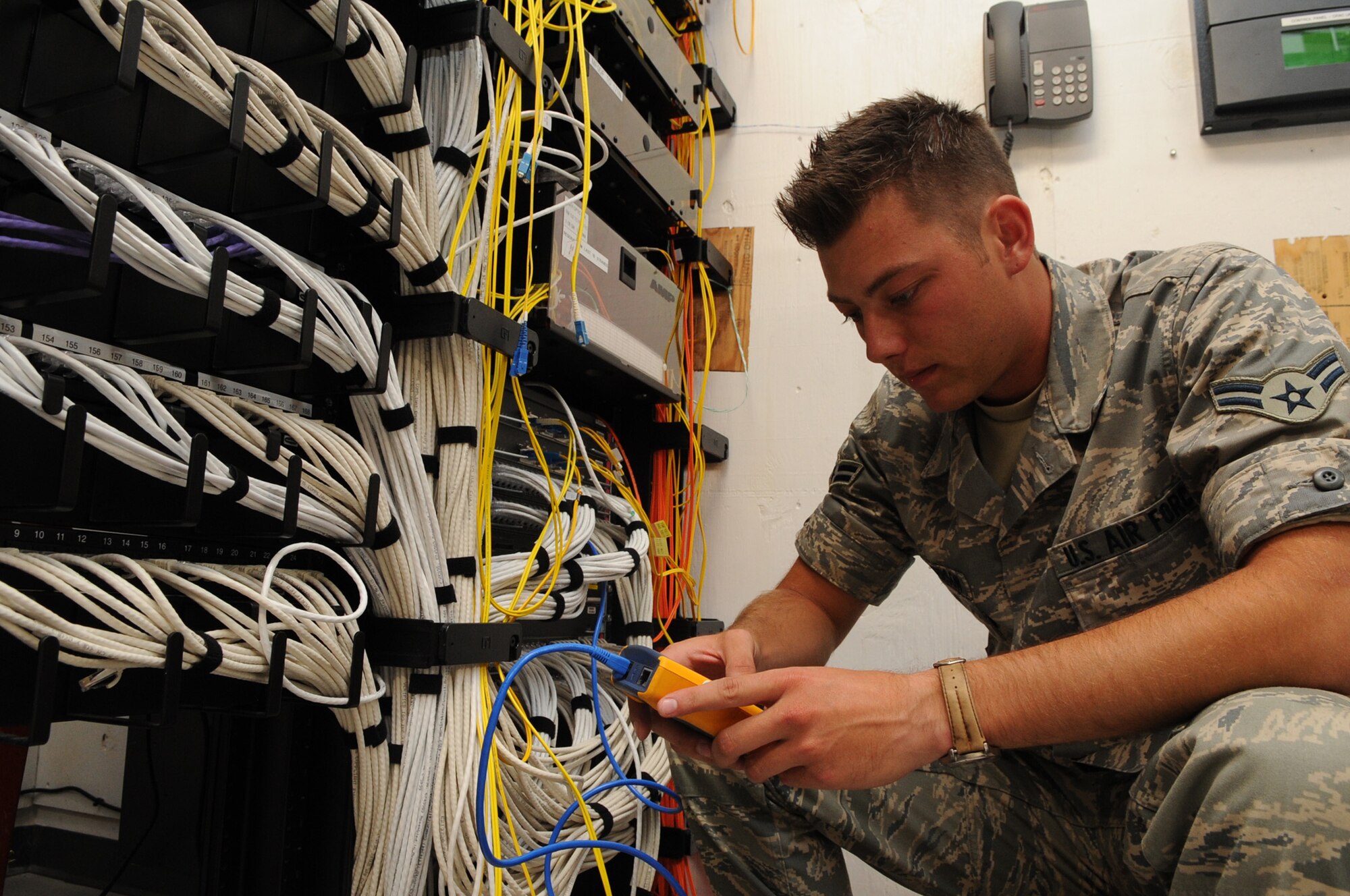 Airman 1st Class Adam Christopherson, 460th Space Communications Squadron network management technician, tests network cable July 22. Airman Christopherson is Team Buckley’s Warrior of the Week for July 25 – Aug. 1.