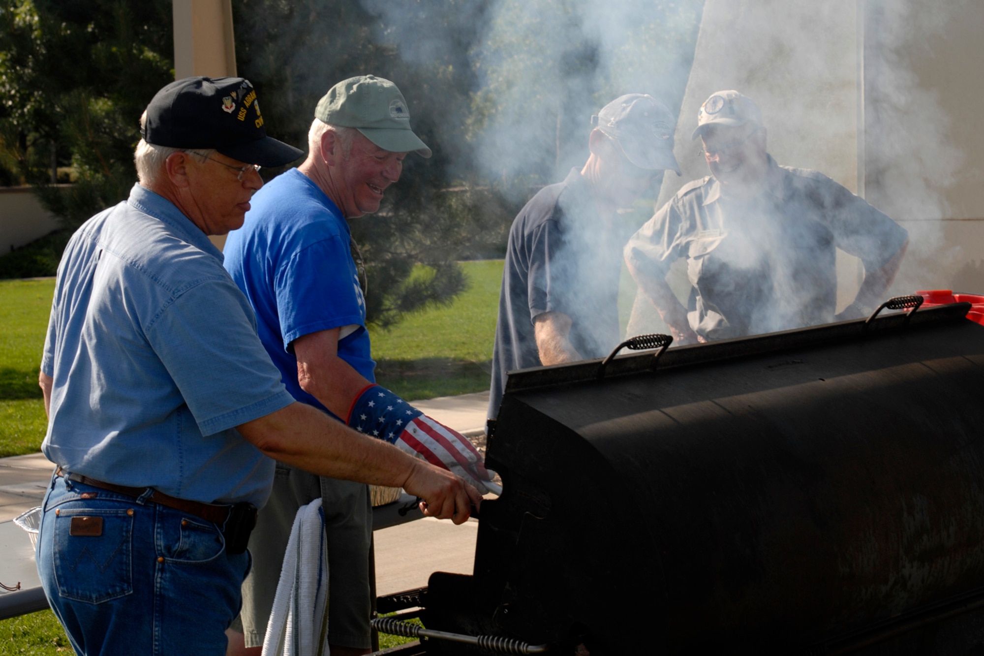 Volunteers grill at the air park during the Peterson Air and Space Museum 2009 Concert in the Park July 31. About 250 attendees along with approximately 60 volunteers including the Civil Air Patrol cadets gathered at the base air park for food and music. (Air Force photo by Larry Hulst)