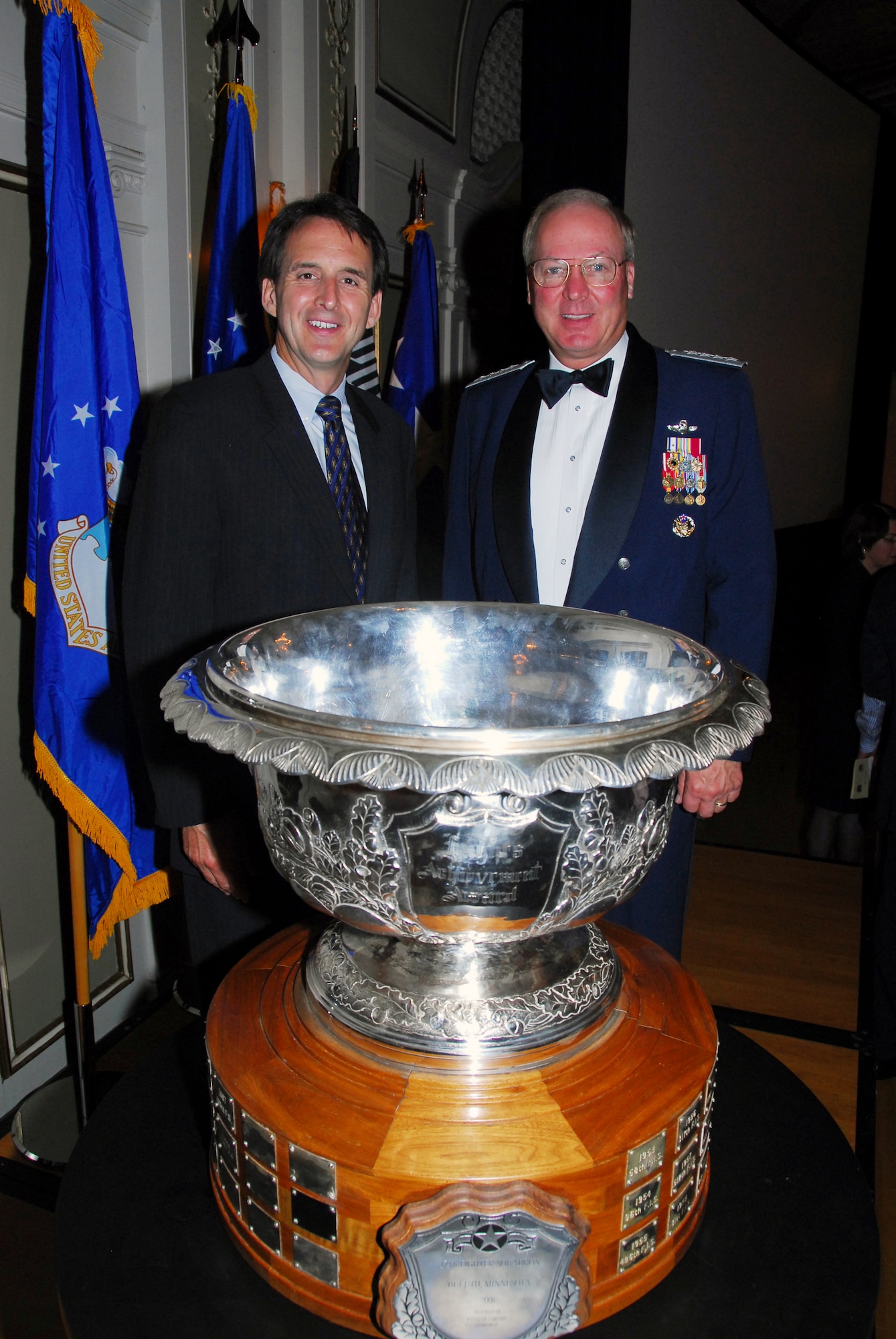 Minnesota Governor Tim Pawlenty (left) poses with U.S. Air Force General Craig R. McKinley-Chief, National Guard Bureau, after the presentation to the 148th Fighter Wing, Duluth, Minn. of the prestigious Raytheon Trophy July 31, 2009 in Duluth, Minn.  The Raytheon Trophy was awarded to the 179th Fighter Squadron of the 148th Fighter Wing as the most outstanding air defense unit in the U.S. Air Force, marking only the fourth time an Air National Guard unit received this award since its inception in 1953.  (U.S. Air Force photo by Tech. Sgt. Brett R. Ewald)
