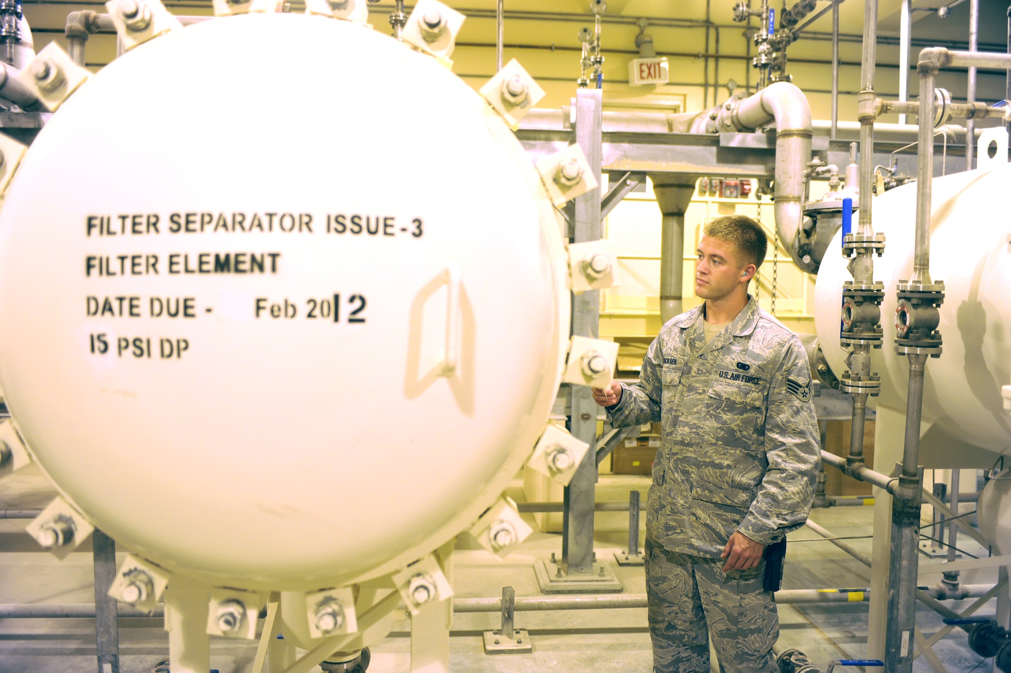 SOUTHWEST ASIA - Senior Airman Chris Ericksen, 380th Expeditionary Logistics Readiness Squadron, reads the fuel pressure of a JP-8 fuel filter element Aug 3. Airman Ericksen checked each of the fuel filter elements after the main fuel system generator was repaired. Airman Ericksen is a fuel storage journeyman from Minot Air Force base, N.D., and hails from Soiux Falls, N.D. (U.S. Air Force photo Tech. Sgt. Charles Larkin Sr.)
