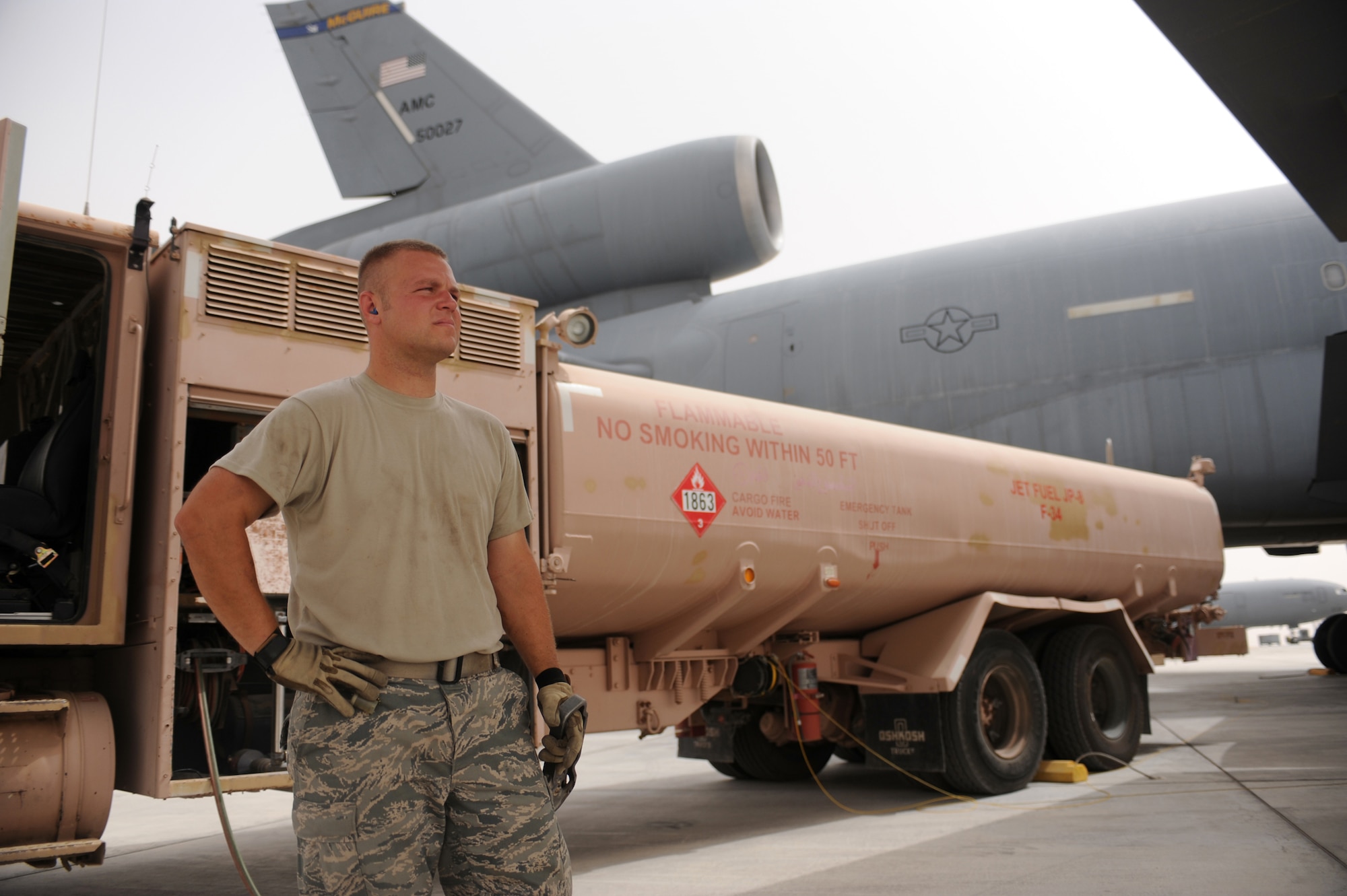 SOUTHWEST ASIA - Staff Sgt. Nicholas Jakubisin, 380th Expeditionary Logistics Readiness Squadron, controls the flow of fuel from a refuel truck to a KC-10 aircraft using what is commonly called the deadman's switch Aug 3. Sergeant Jakubisin is a fuels craftsman from Hill Air Force base, Utah, and hails from Salt Lake City, Utah. (U.S. Air Force photo Tech. Sgt. Charles Larkin Sr.)