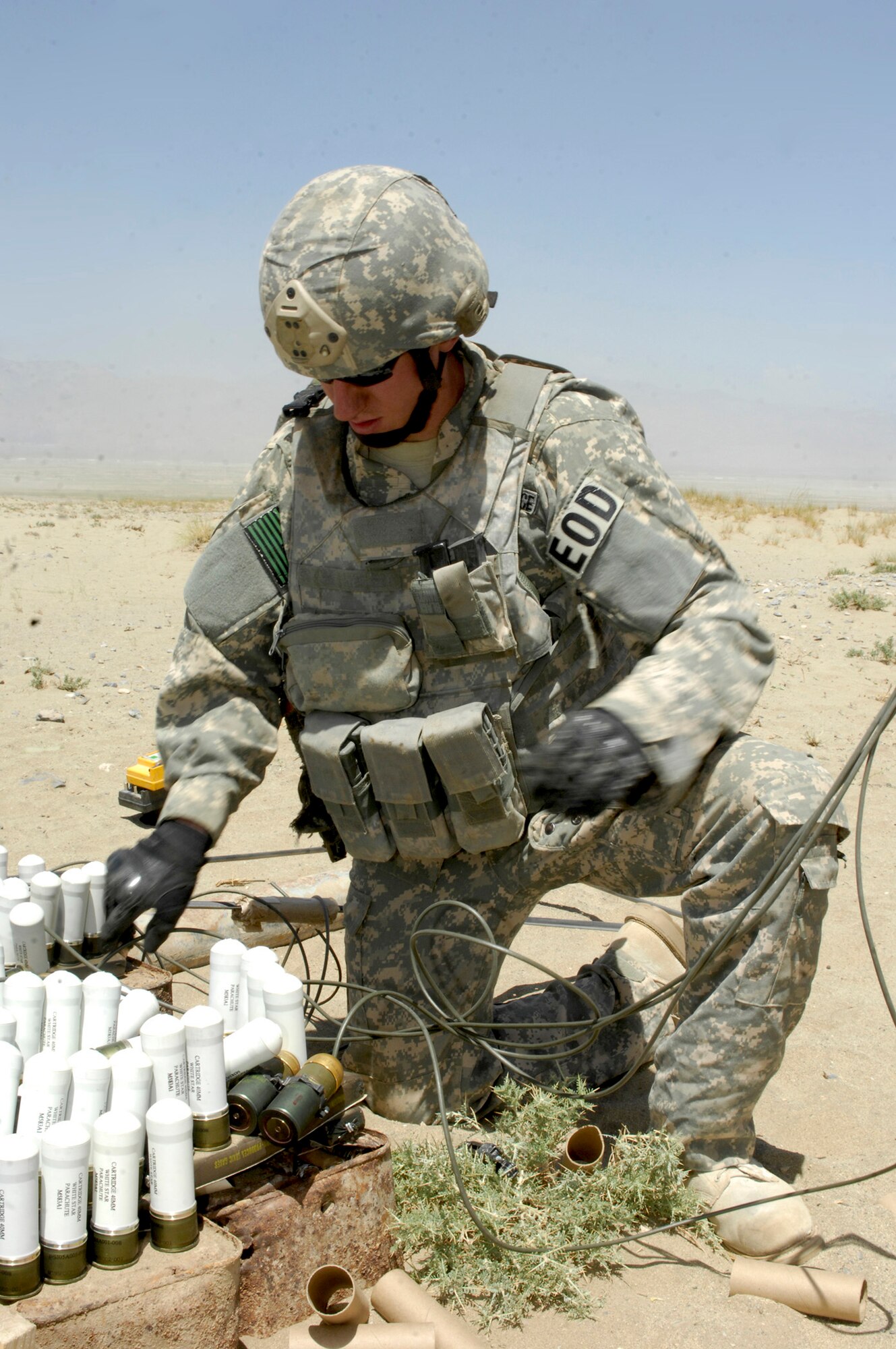 Staff Sgt. Greg Talley inserts blasting caps into C-4 explosive charges at a ordnance disposal range Aug. 2 near Bagram Airfield, Afghanistan. Several hundred pounds of mixed ordnance, including discarded Soviet munitions from the 1970s, were destroyed. Sergeant Talley is an explosive ordnance disposal technician with the 755th Air Expeditionary Group, and deployed from Dyess Air Force Base, Texas. (U.S. Air Force photo/Tech. Sgt. John Jung)