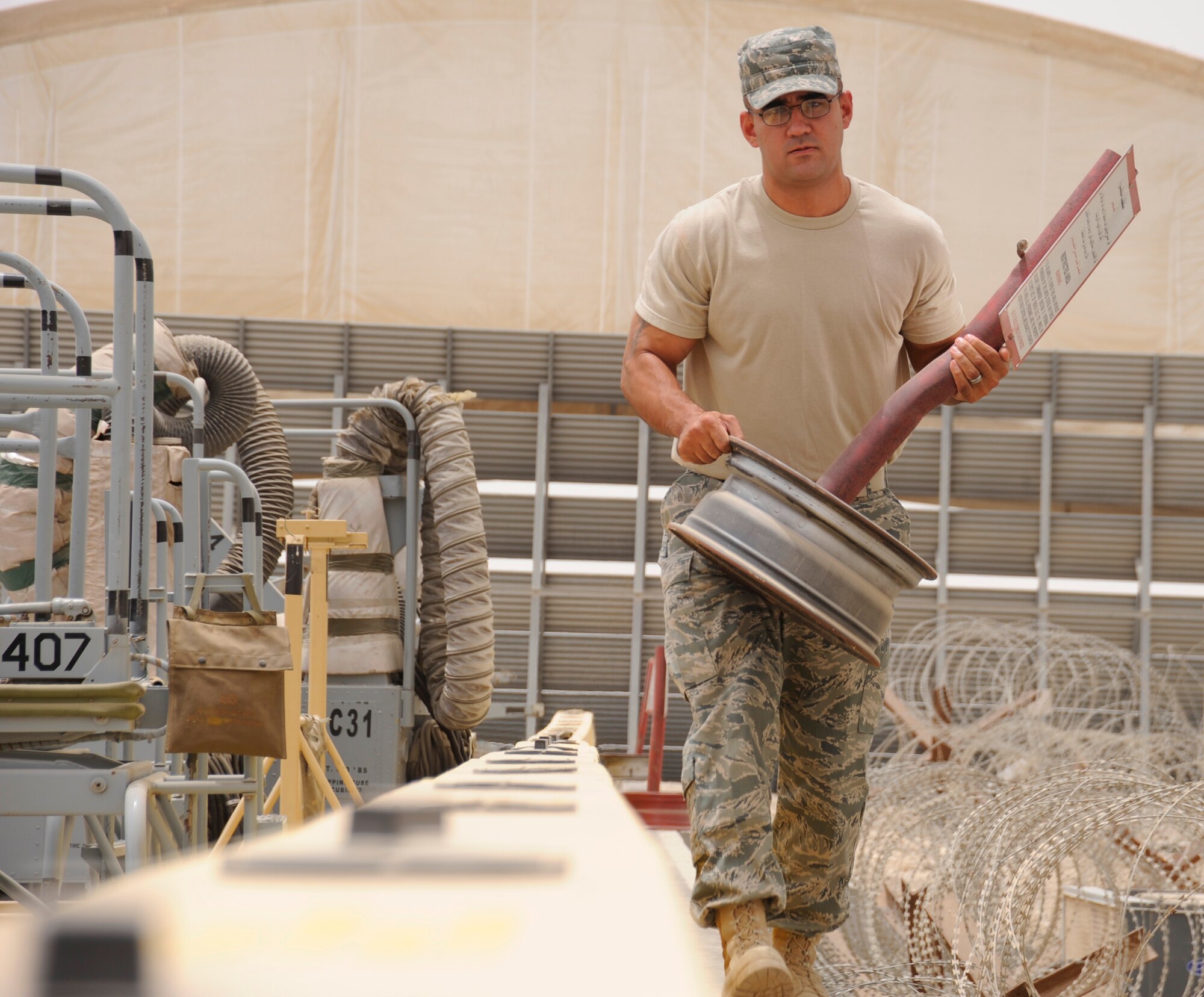 SOUTHWEST ASIA – Tech. Sgt. Erik Castro, 380th Expeditionary Security Forces Squadron, moves a restricted area sign Aug. 5. Sergeant Castro is deployed from Keesler AFB, Miss., and hails from Bell Gardens, Calif. (U.S. Air Force photo/Senior Airman Stephen Linch)