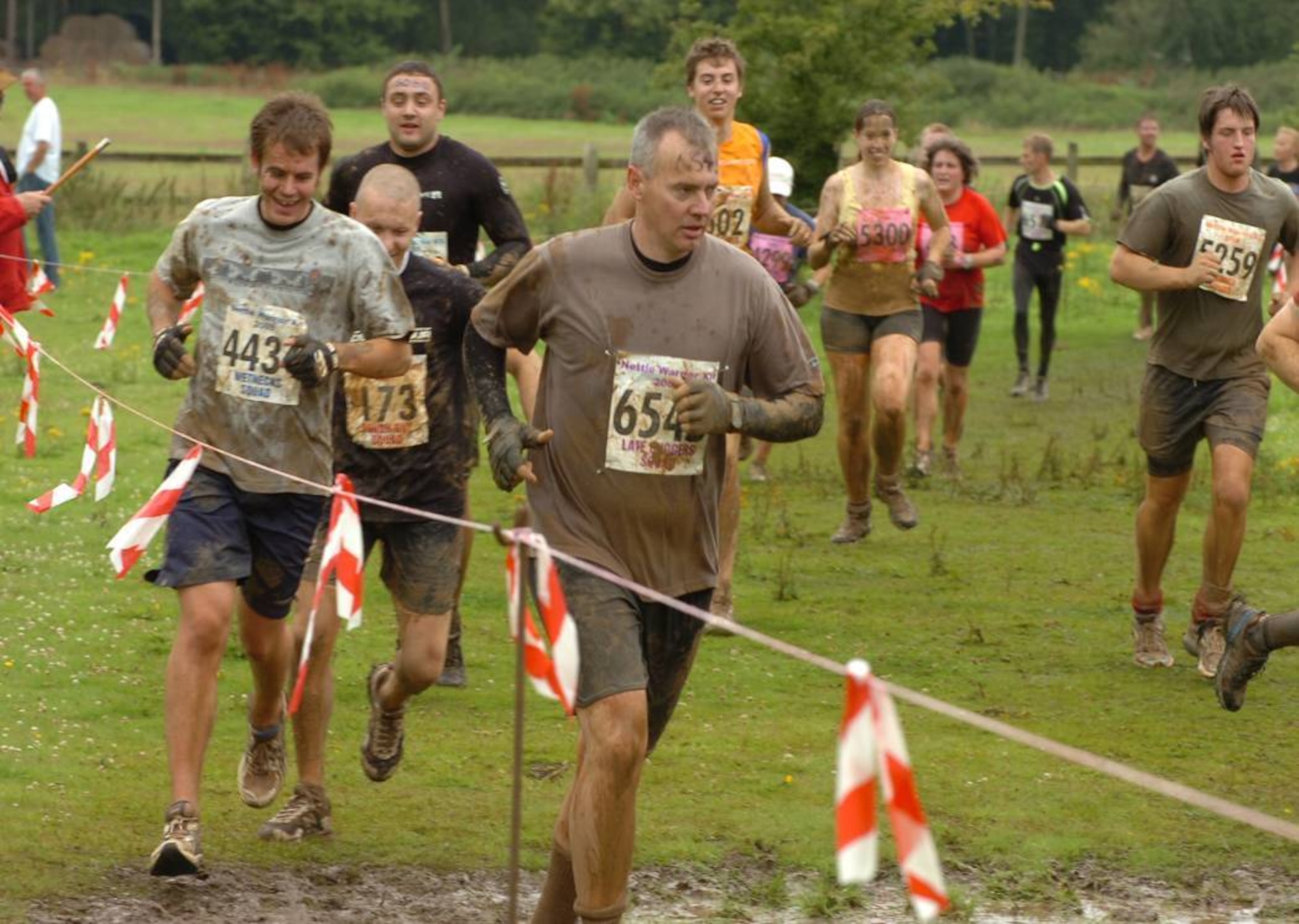 JAC Senior Enlisted Advisor, Navy Master Chief John C. Frakes (#6545) runs during UK TOUGH GUY summer 2009 in Old Perton, England.  The Master Chief was part of the nine member JAC HAMMERS team in the event.  (U.S. Air Force photo by Staff Sgt. Rachel Goff)