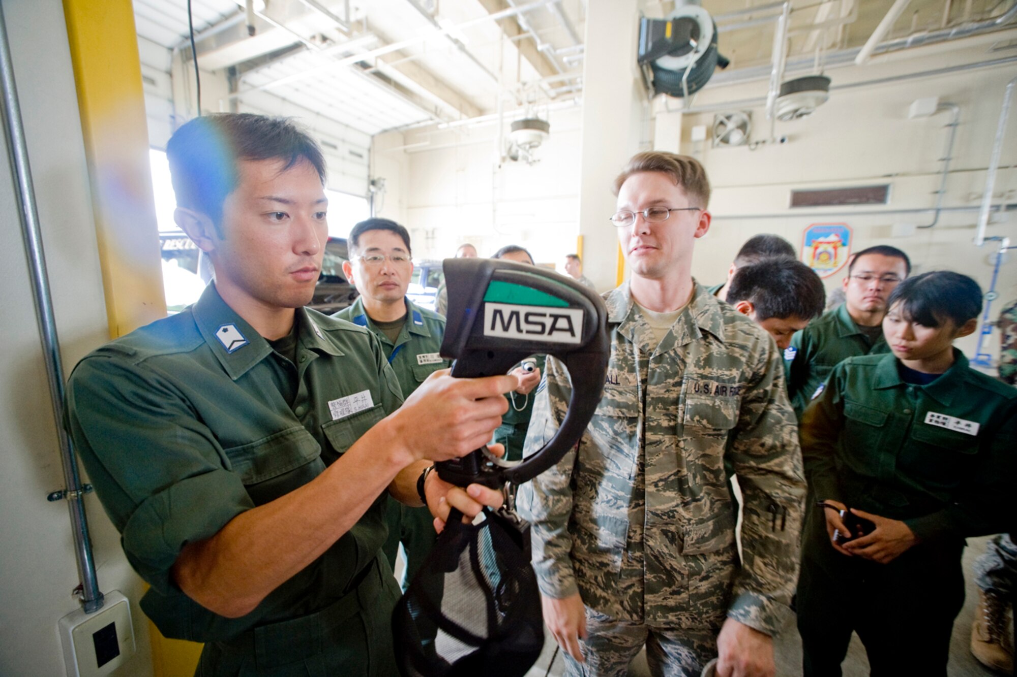 MISAWA AIR BASE, Japan -- Staff Sgt. Shinya Hirai, Japan Air Self-Defense Force field maintenance squadron member, observes a thermal imaging camera during a tour to the 35th Civil Engineer Squadron's Fire Station 1 July 28. The tour was part of a bi-lateral exchange that paired JASDF personnel with U.S. Air Force personnel of similar specialties. (U.S. Air Force photo/Senior Airman Jamal D. Sutter) 