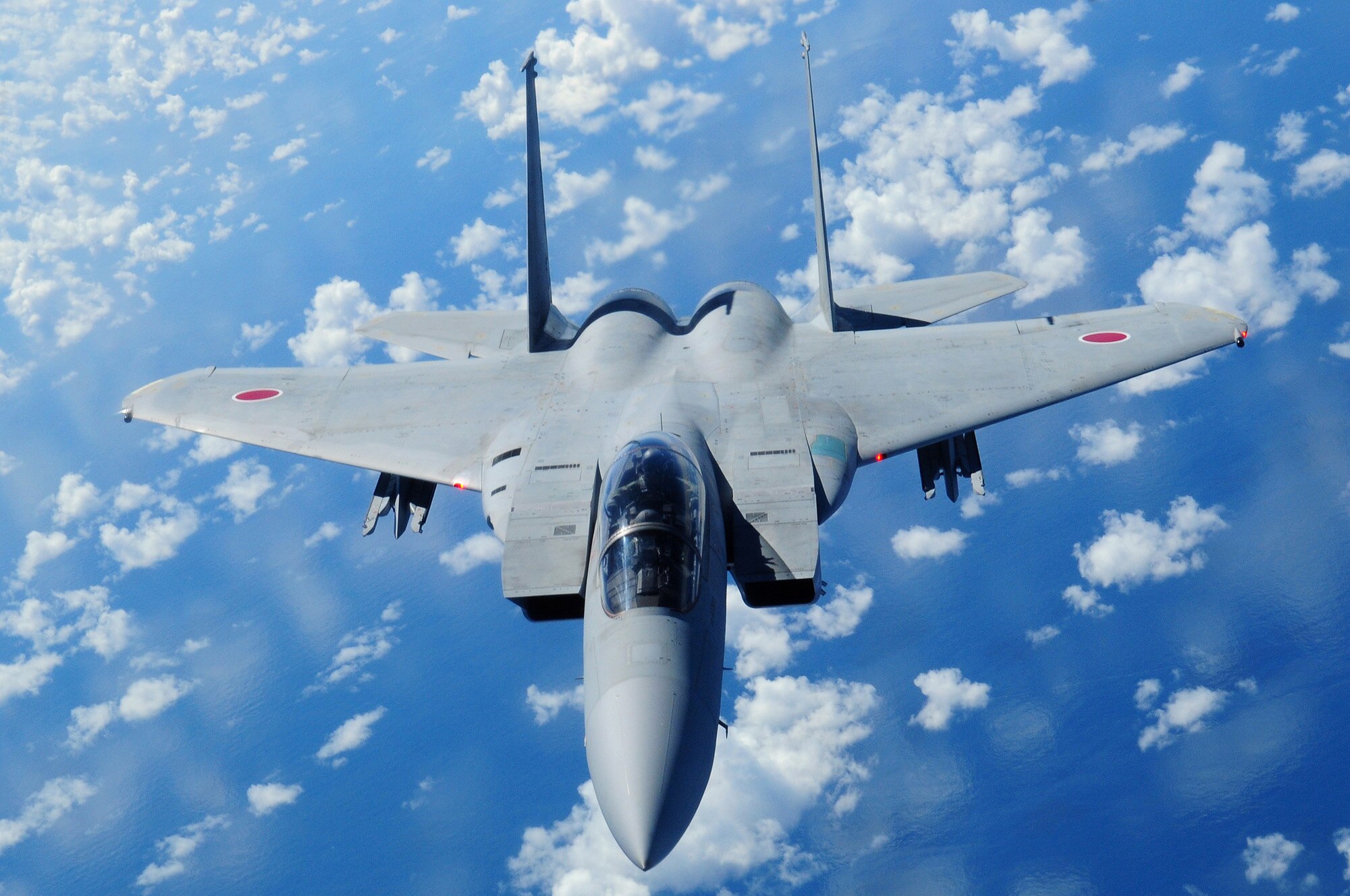 A Japan Air Self Defense Force F-15 flies alongside a U.S. Air Force KC-135 from the 909th Air Refueling Squadron, Kadena Air Base, after being refueled during air refueling training July 30. The training is in preparation for JASDF participation in Red Flag Alaska this year. (U.S. Air Force photo/Tech. Sgt. Angelique Perez) 