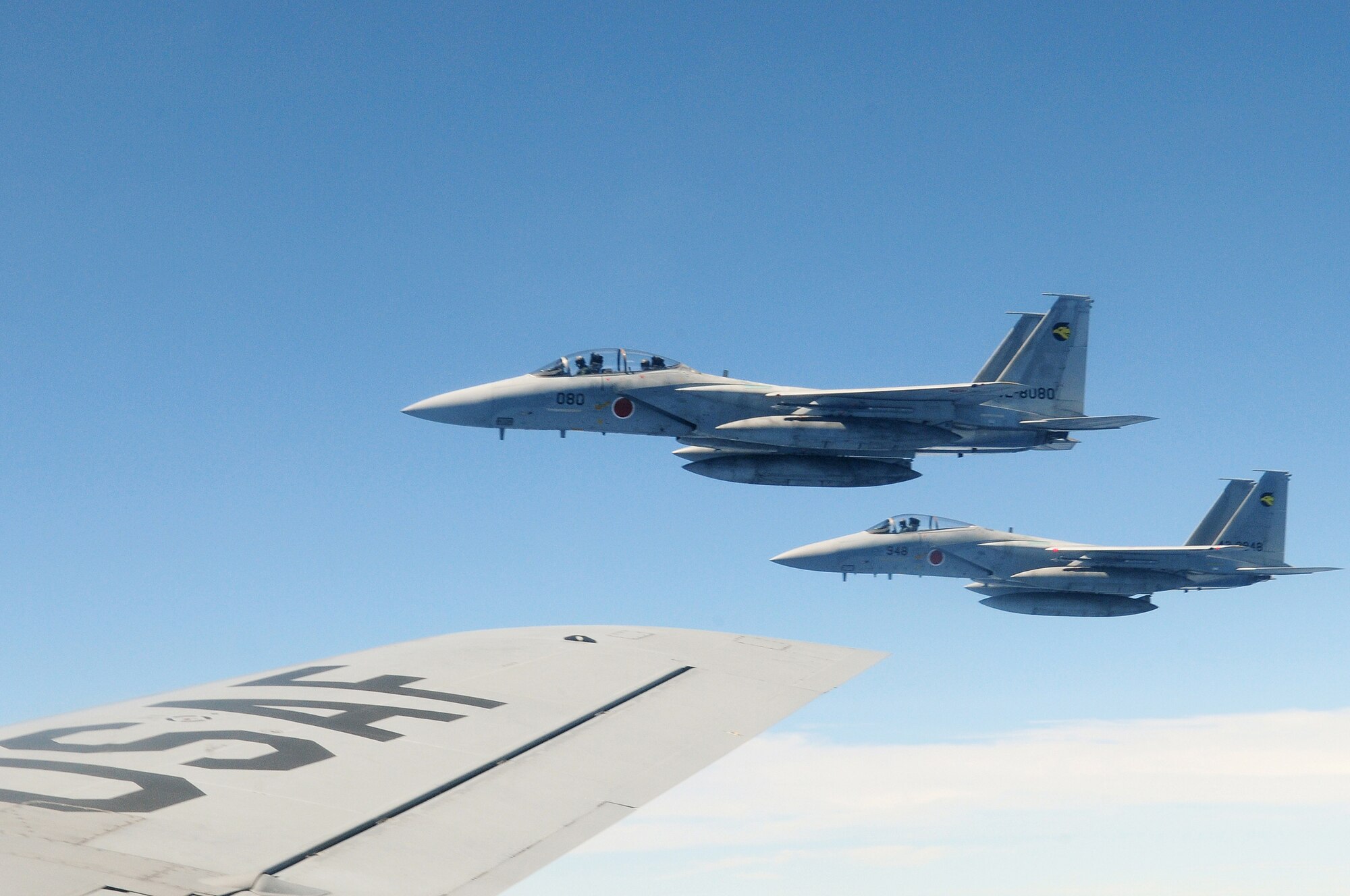 Two Japan Air Self Defense Forces F-15's fly alongside a U.S. Air Force KC-135 from the 909th Air Refueling Squadron, Kadena Air Base, during air refueling training July 30. The training is in preparation for JASDF participation in Red Flag Alaska this year.
(U.S. Air Force photo/Tech. Sgt. Angelique Perez) 