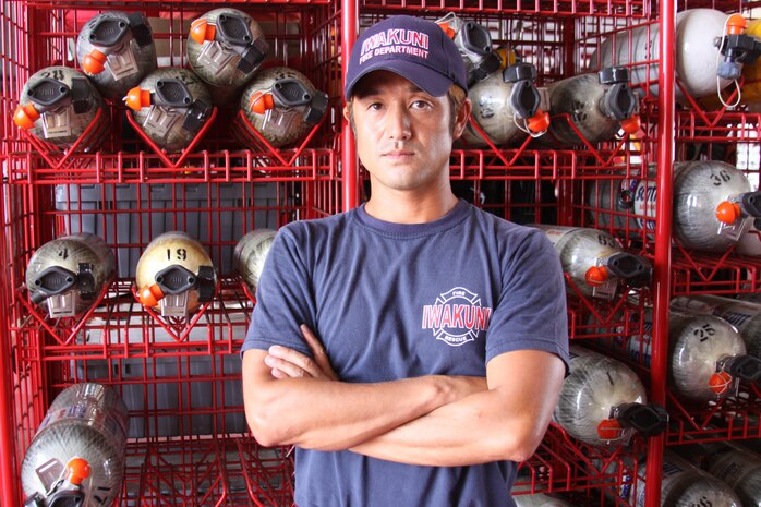 Ken Kobayashi, a firefighter here, poses in front of equipment at the station fire department here. Kobayashi saved a gentleman from choking to death at the Mikawa Town Summer Festival Aug. 2. This was not the first time he has saved a life. During Kobayashi’s off time, he serves as a lifeguard at the station pools.
