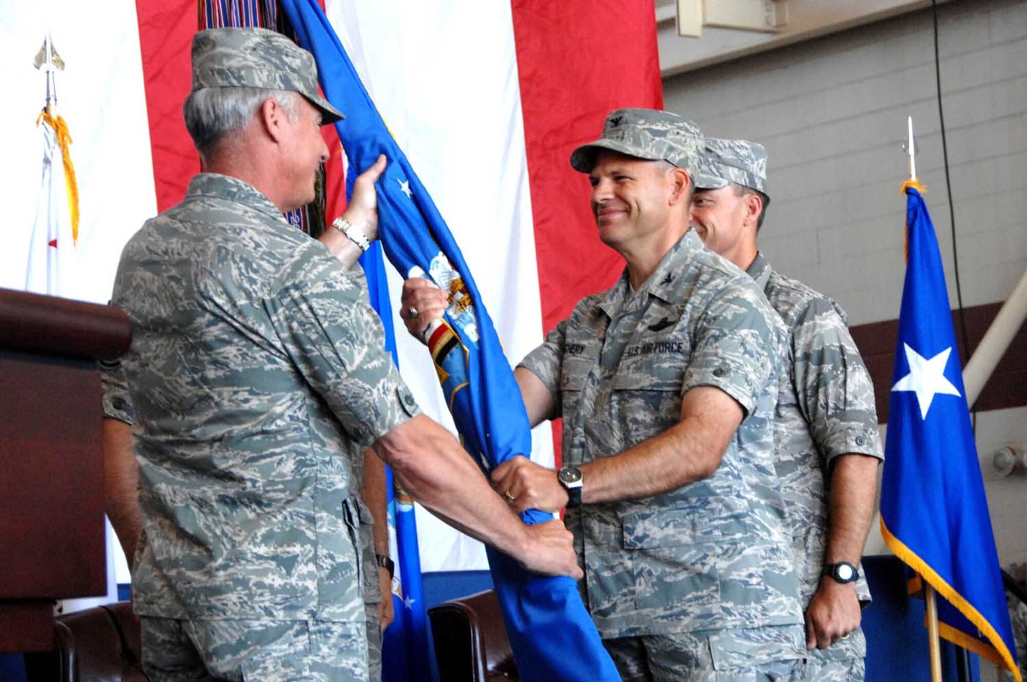 Maj. Gen Winfield Scott III, 18th Air Force commander, hands the 60th Air Mobility Wing guideon to Col. James Vechery, 60th AMW commander, during the 60th AMW change-of-command ceremony July 17. (U.S. Air Force photo/Amanda Lopez)

