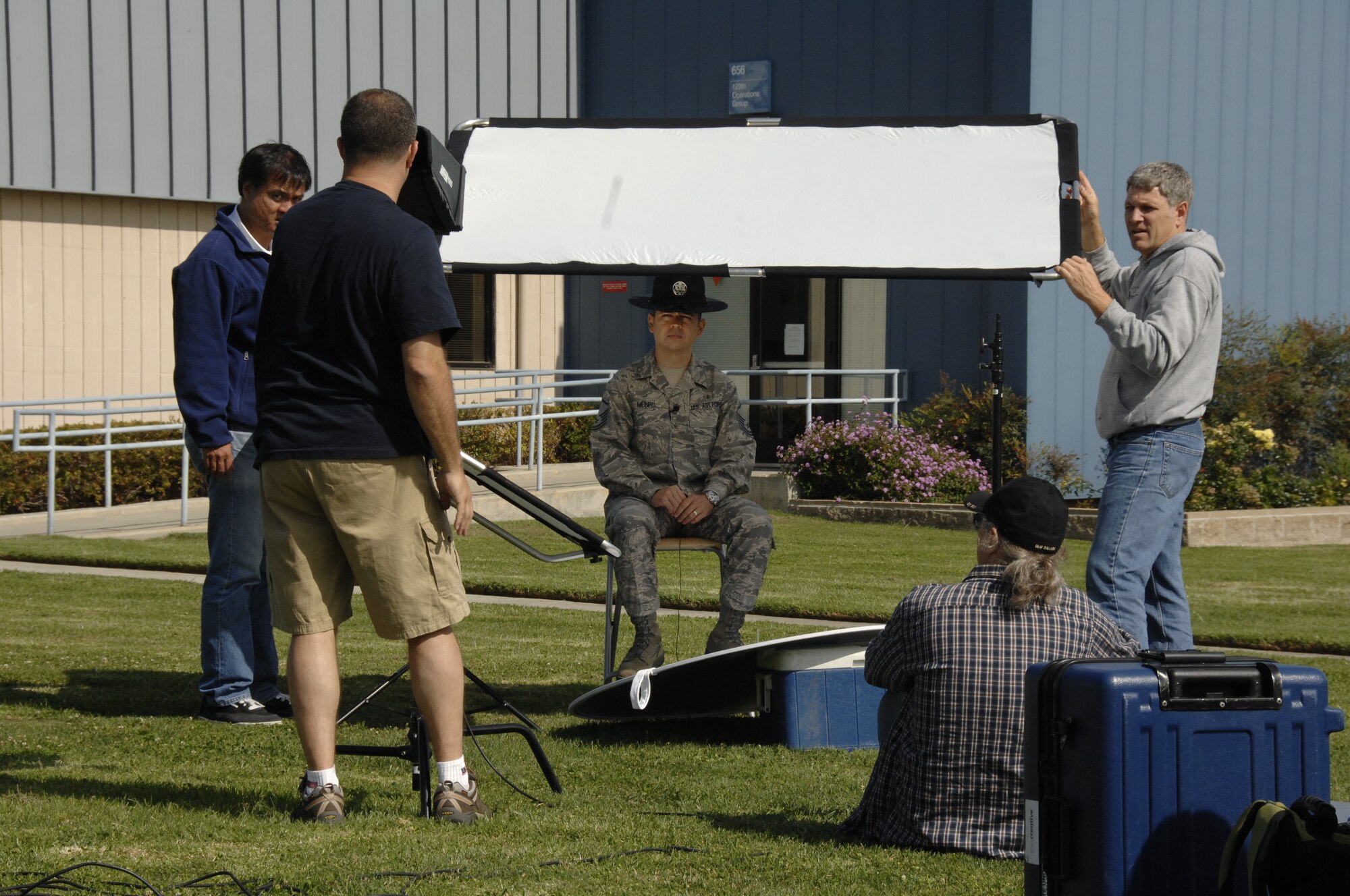 Members from the Air National Guard Advertising and Marketing team set up video equipment for an interview with Master Sgt. Alan Munro, a former military training instructor and a member of the 129th Medical Group, during a video and photo shoot for the redesign of GoANG.com at Moffett Federal Airfield, Calif., Aug. 1, 2009.  (Air National Guard photo by Senior Airman Shane Burke)