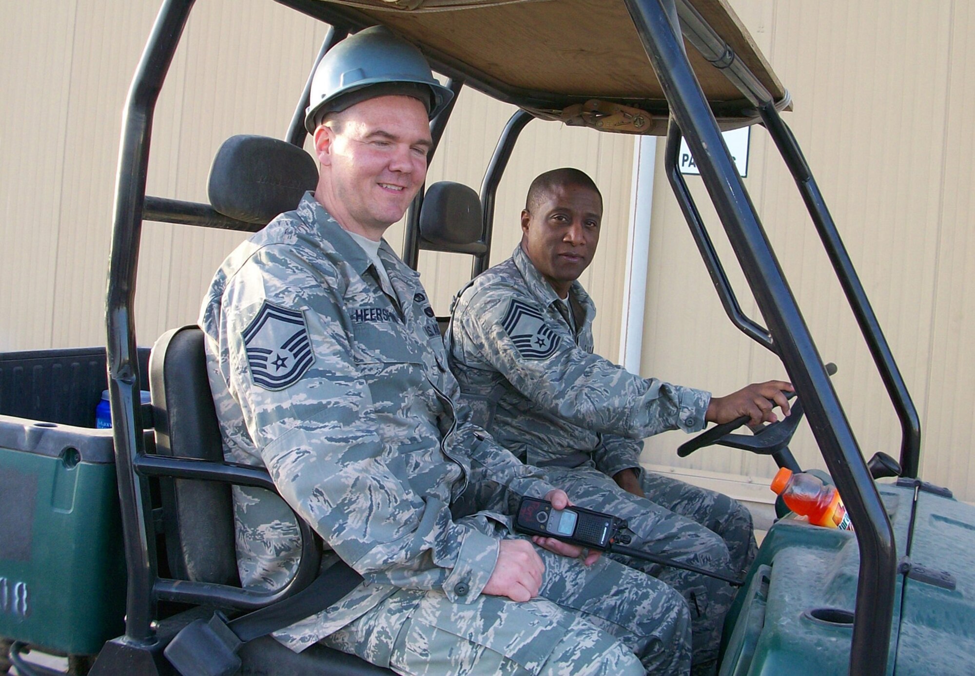 Senior Master Sgt. Franklin Heerspink, left, and Chief Master Sgt. Arthur Green, both with the 36th Aerial Port Squadron, McChord Air Force Base, Wash., perform a yard check on all of the aerial port's areas of responsibility while deployed at Balad Air Base, Iraq. The 86th and 36th Aerial Port Squadrons were deployed December 2008 to May 2009. (U.S. Air Force photo/Master Sgt. Denise White) 