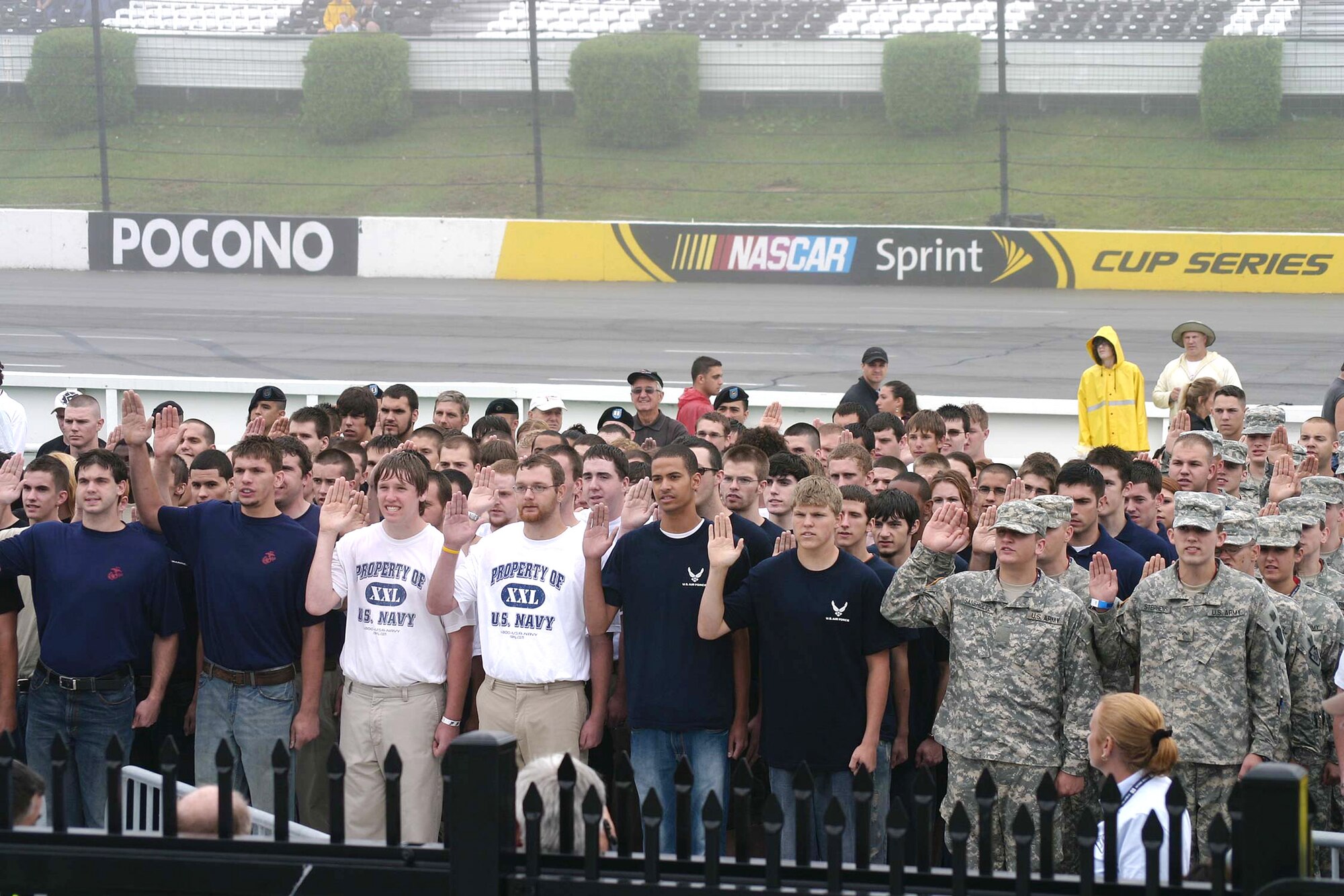 Approximately 100 young men and women destined for the Air Force, Army, Navy or Marines take the oath of enlistment into their respective military service's delayed-entry program at the Pocono Raceway Aug. 2. Air Force Chief of Staff Gen. Norton Schwartz conducted the joint-service ceremony. (U.S. Air Force photo/Dale Eckroth)  
