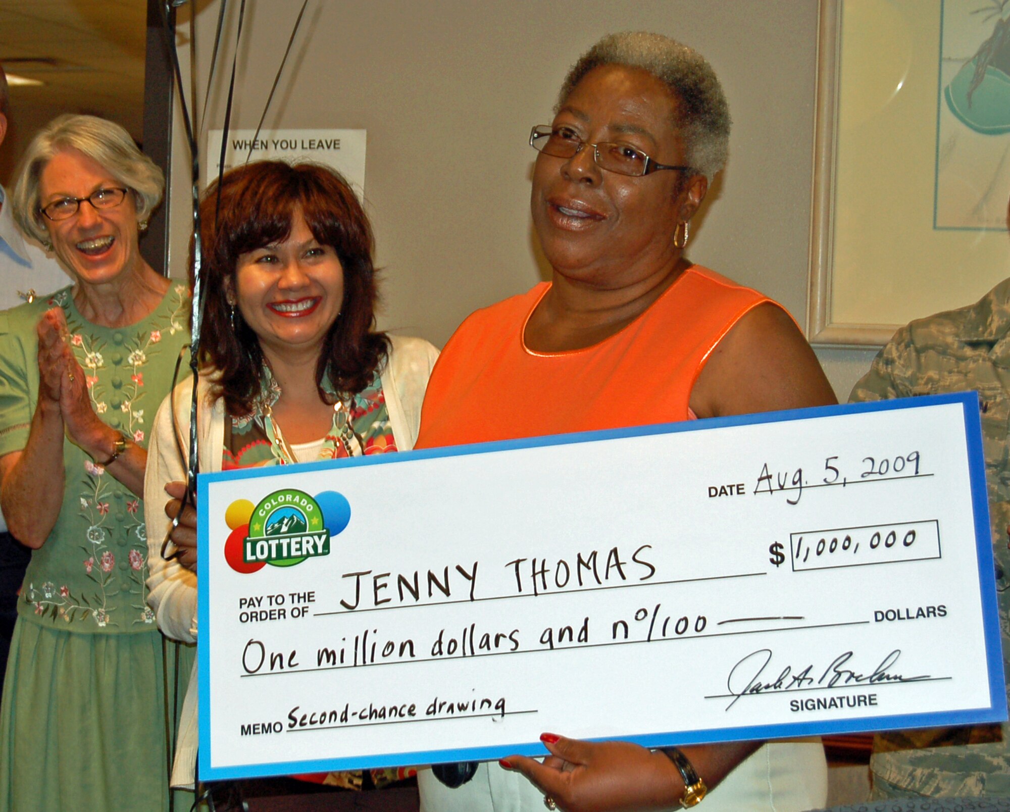 Jenny Thomas, 21st Contracting Squadron procurement technician, holds a Colorado Lottery check for $1 million in the squadron conference room Wednesday. Ms. Thomas won a second chance lottery drawing; the $1 million prize is the largest Colorado lottery award. Ms. Thomas said she will use the money to renovate her mother’s home and arrange ongoing care for her mother. (Air Force photo by Thea Skinner)