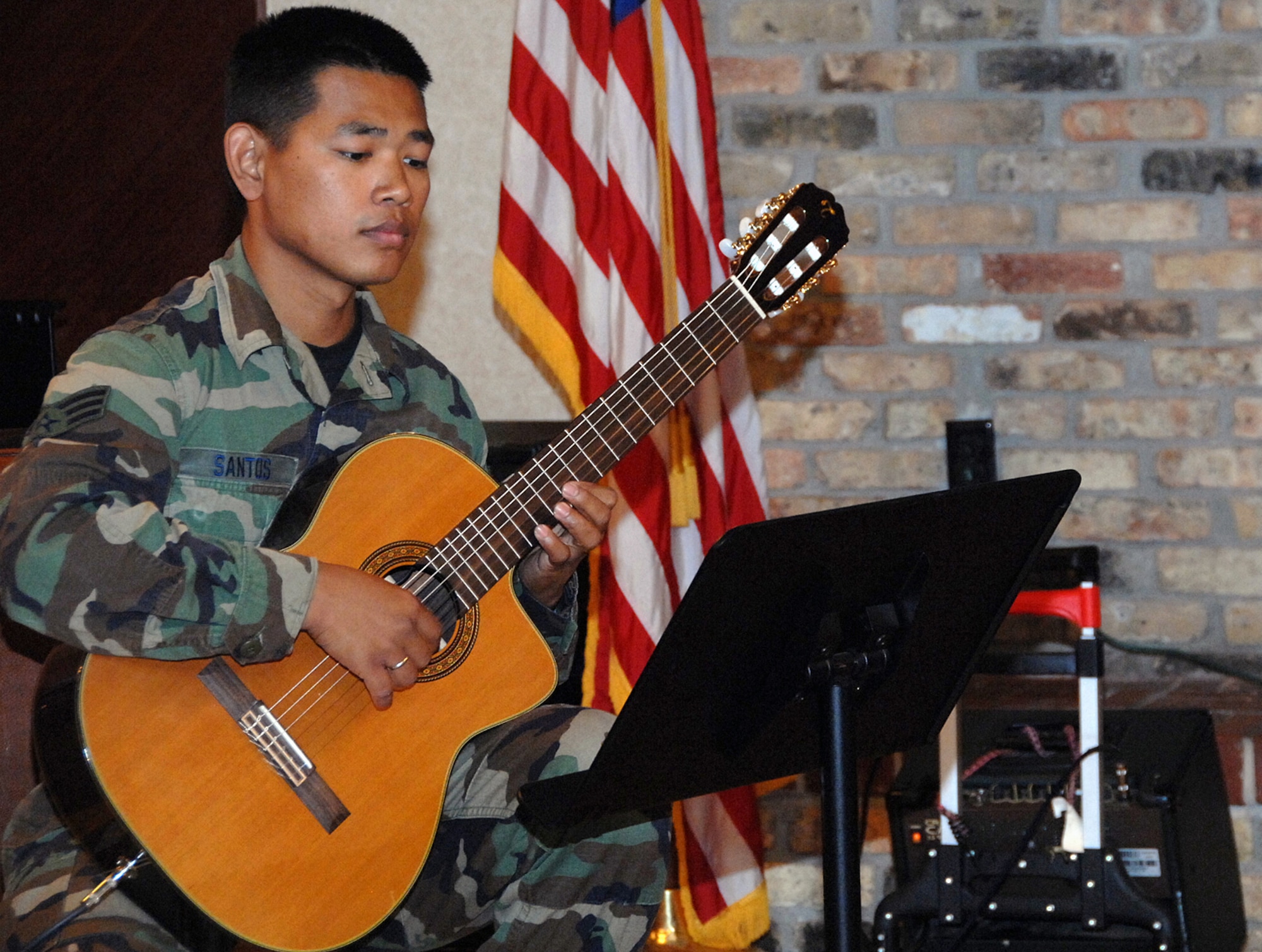 OFFUTT AIR FORCE BASE, Neb.-- Senior Airman Daniel Santos, a guitarist with the Heartland of America Band, plays a solo on his classical guitar during the July 31 Lunch Bachs concert at the Community Activity Center.The Lunch Bach is a free four-part series during the Offutt lunch hour. US Air Force photo by Kendra Williams