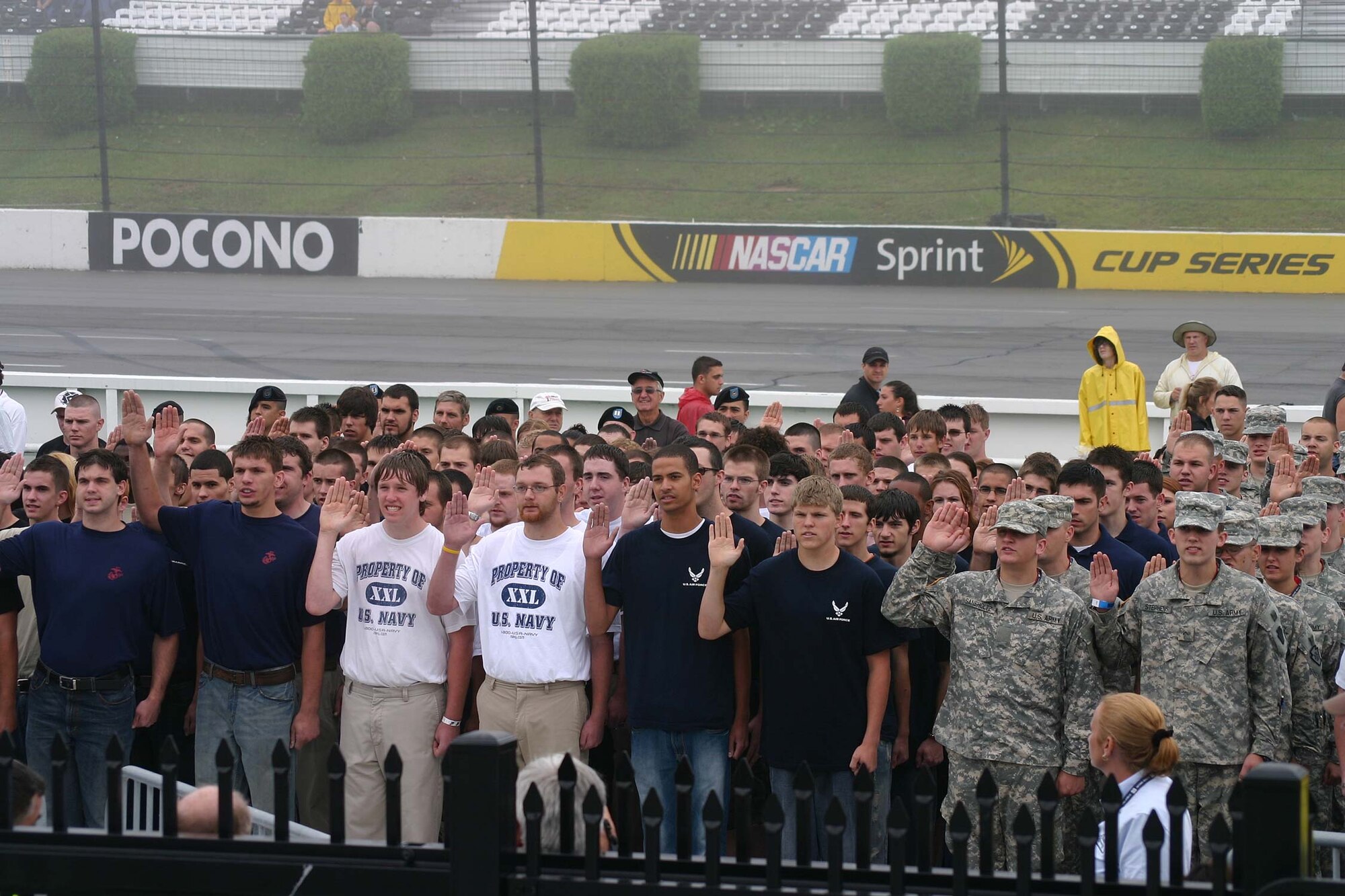 Approximately 100 young men and women take the oath of enlistment into their respective military service's Delayed Entry Program at the Pocono Raceway Aug. 2. The Air Force's Chief of Staff, Gen. Norton Schwartz, conducted the joint service ceremony. (U.S. Air Force photo/Dale Eckroth)
