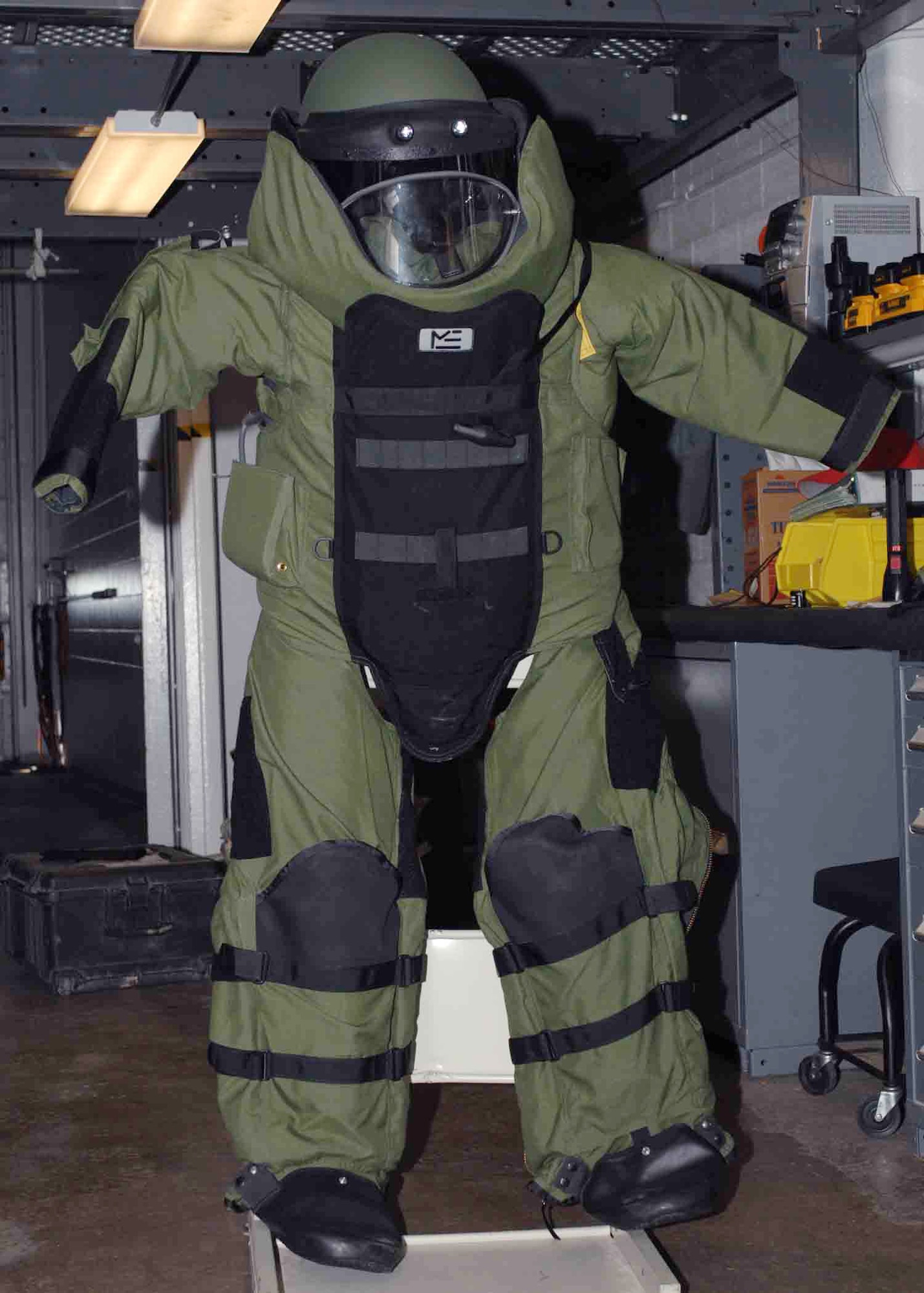 An explosive ordnance disposal bomb suit hangsJuly 29 at Cannon Air Force Base, N.M. The suit is made of Kevlar with metal plates and can protect a body from a blast within arms reach. (U.S. Air Force photo/Airman 1st Class James Bell) 
