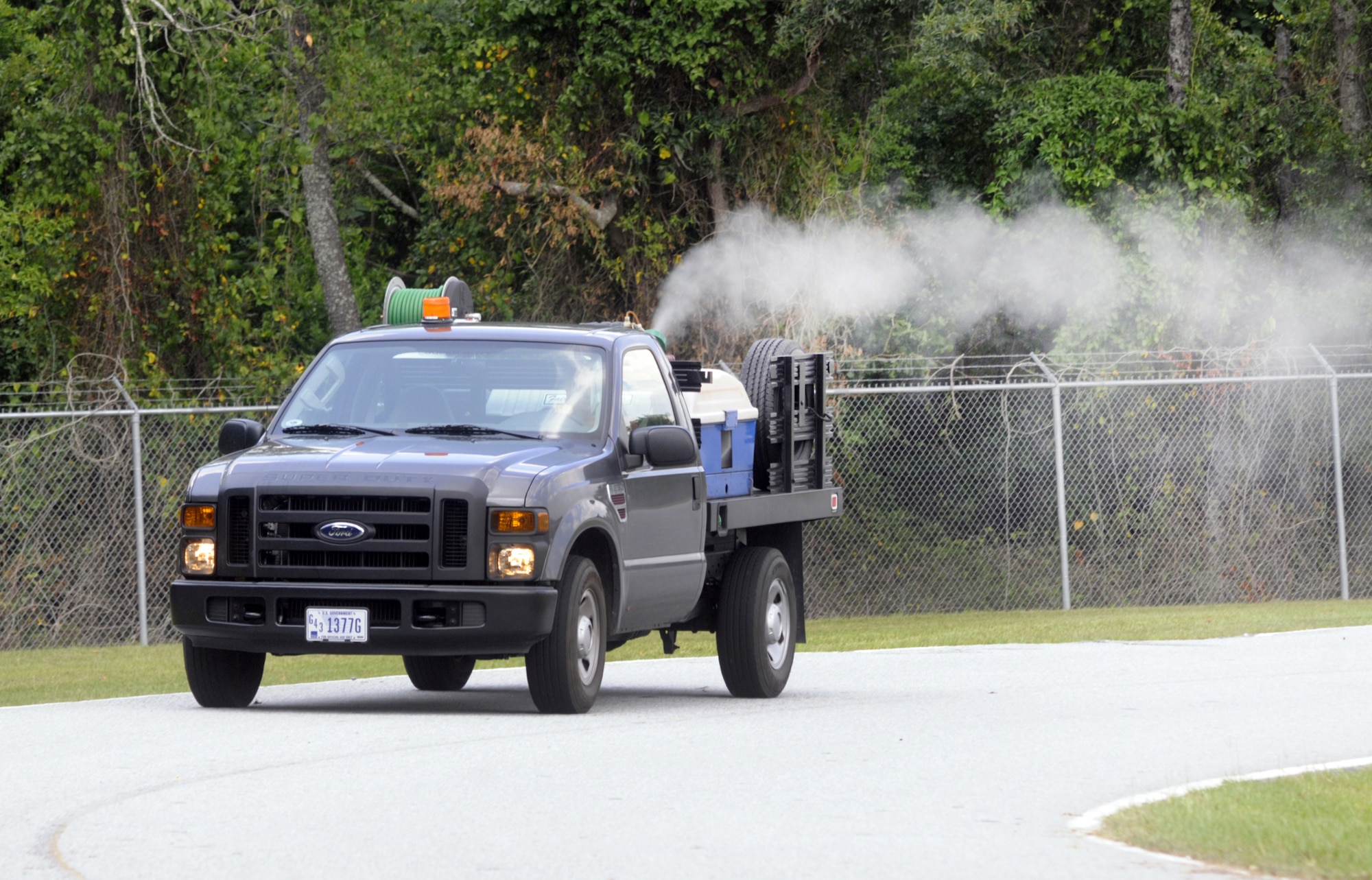 The shop sprays for mosquitoes when the mosquito count from public health is high. Carey Quinn is driving this truck. U. S. Air Force photo by Sue Sapp