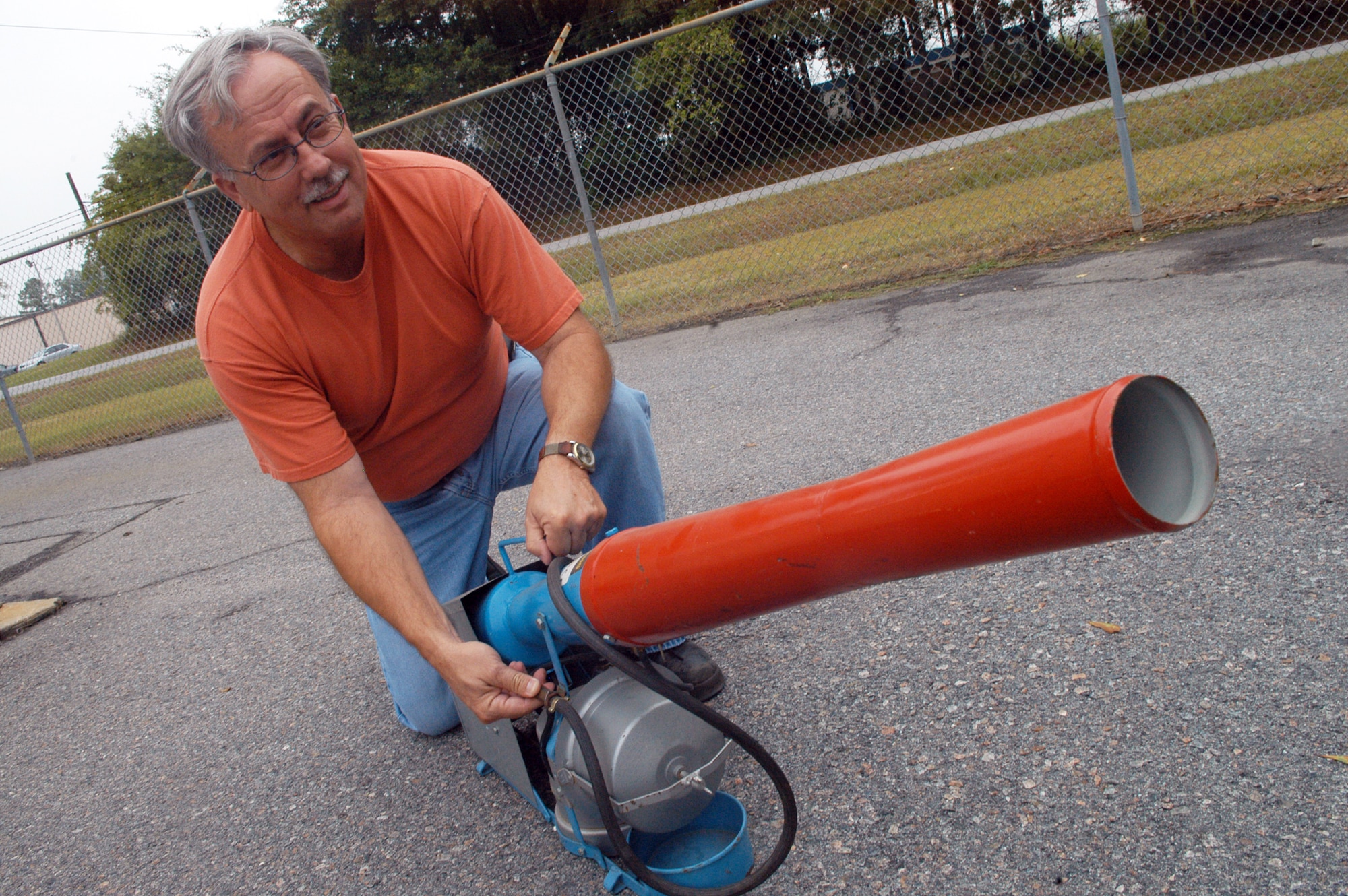 Danny Jones shows a bird cannon used to scare birds away from the flight line. U. S. Air Force photo by Sue Sapp    