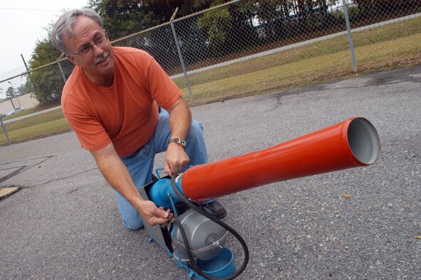 Danny Jones shows a bird cannon used to scare birds away from the flight line. U. S. Air Force photo by Sue Sapp    
