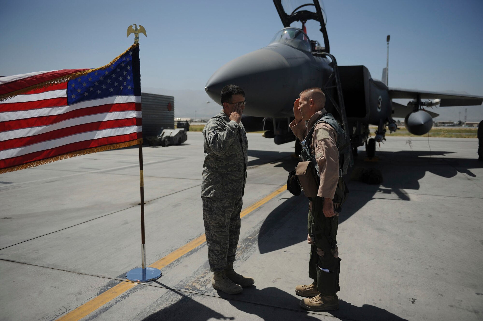 BAGRAM AIRFIELD, Afghanistan - Tech. Sgt. Lucas Dechant, a 12-year Air Force veteran, reenlists in front of an F-15E Strike Eagle. The 455th Air Expeditionary Wing commander, Brig. Gen. Steven L. Kwast, presided over the ceremony where friends and coworkers from the maintenance squadron gathered. A Denver native, Sergeant Dechant is on his fourth deployment. He is stationed at Seymour Johnson Air Force Base, N.C. (U.S. Air Force photo/Staff Sgt. J.G. Buzanowski)
