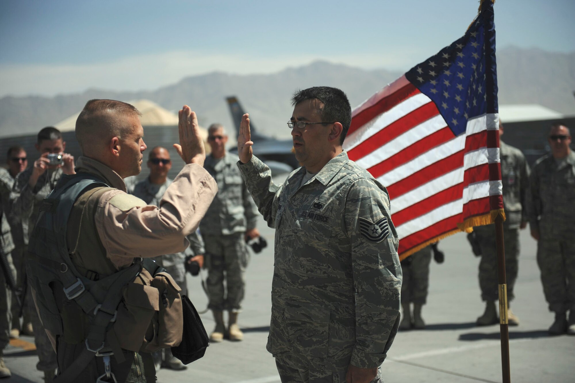 BAGRAM AIRFIELD, Afghanistan - Tech. Sgt. Lucas Dechant, a 12-year Air Force veteran, reenlists in front of an F-15E Strike Eagle. The 455th Air Expeditionary Wing commander, Brig. Gen. Steven L. Kwast, presided over the ceremony where friends and coworkers from the maintenance squadron gathered. A Denver native, Sergeant Dechant is on his fourth deployment. He is stationed at Seymour Johnson Air Force Base, N.C. (U.S. Air Force photo/Staff Sgt. J.G. Buzanowski)