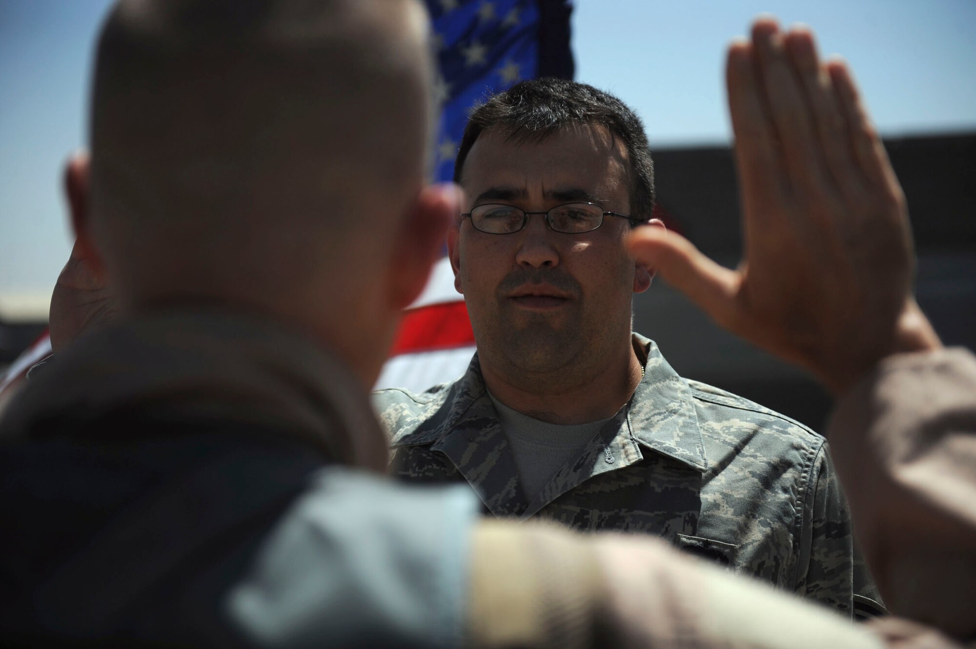 BAGRAM AIRFIELD, Afghanistan - Tech. Sgt. Lucas Dechant, a 12-year Air Force veteran, reenlists in front of an F-15E Strike Eagle. The 455th Air Expeditionary Wing commander, Brig. Gen. Steven L. Kwast, presided over the ceremony where friends and coworkers from the maintenance squadron gathered. A Denver native, Sergeant Dechant is on his fourth deployment. He is stationed at Seymour Johnson Air Force Base, N.C. (U.S. Air Force photo/Staff Sgt. J.G. Buzanowski)