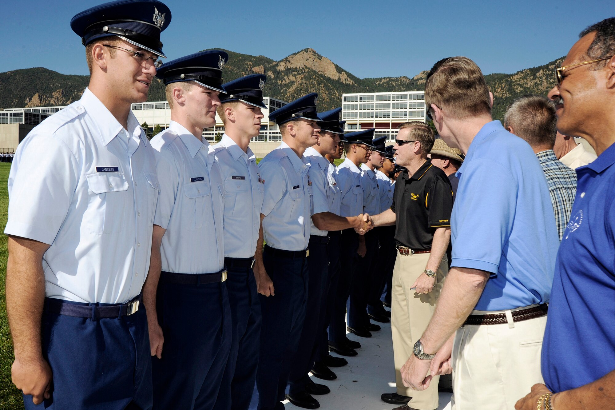 Members of the U.S. Air Force Academy Class of 1973 present members with the cadet handbook, "Contrails," during the Acceptance Parade Aug. 5 at the Academy in Colorado. The parade marks the official end of Basic Cadet Training and formally welcomes the new class into the cadet wing. (U.S. Air Force photo/Dave Ahlschwede) 