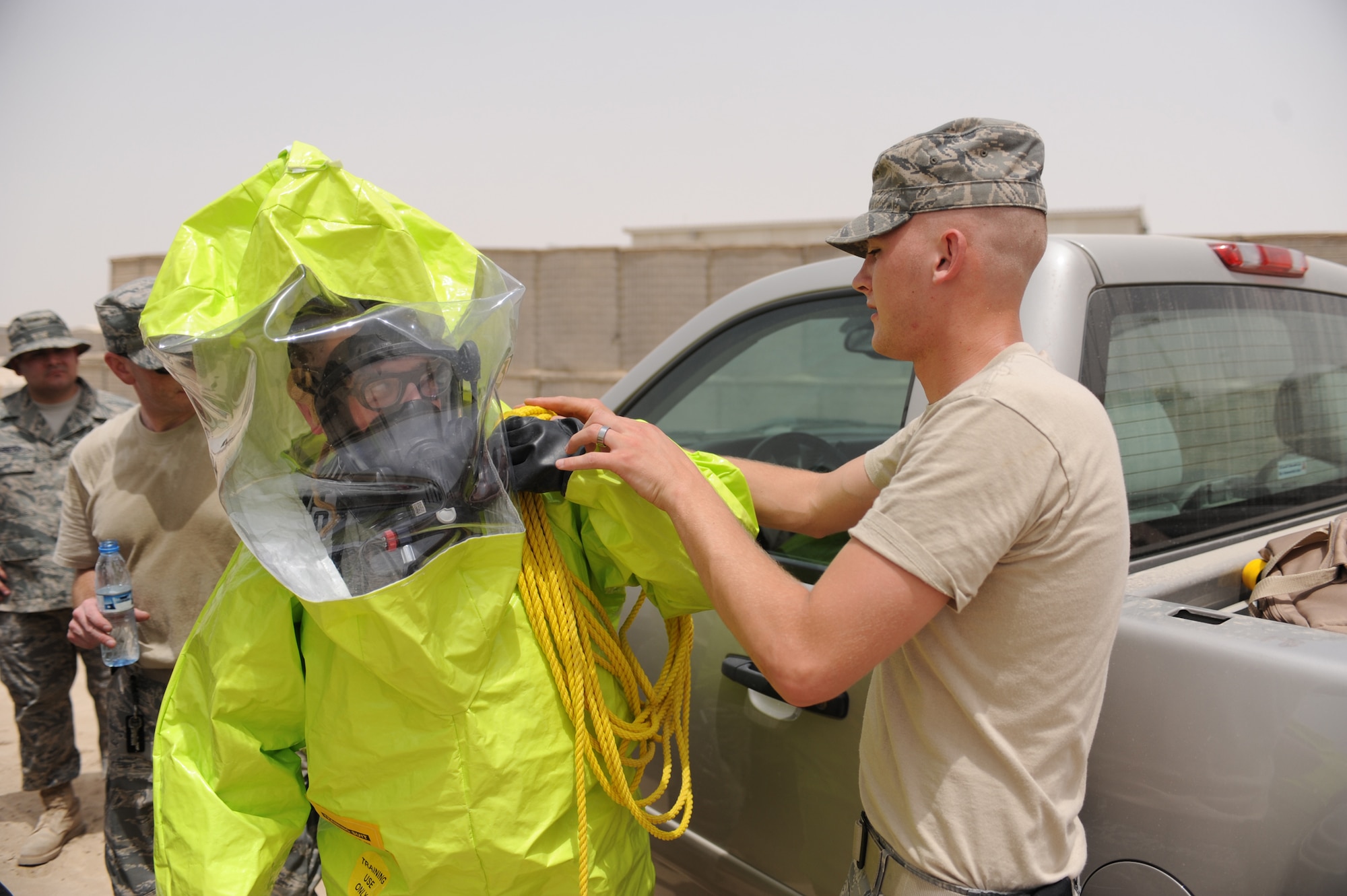 SOUTHWEST ASIA - Airmen from the 380th Expeditionary Civil Engineer Squadron suit up for an emergency management exercise Aug 6. The emergency management team members regularly run through scenarios to ensure properly trained personnel and operational check equipment. (U.S. Air Force photo Tech. Sgt. Charles Larkin Sr.)