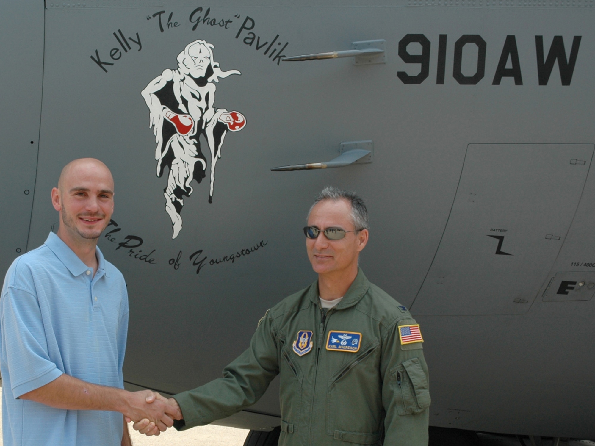 YOUNGSTOWN AIR RESERVE STATION, Ohio -- Col. Karl McGregor, commander of the 910th Airlift Wing here, and Kelly "The Ghost" Pavlik, world middleweight boxing champion, unveil the nose art of a YARS C-130H aircraft outside of Hangar 302 here, Aug. 4, 2009. The nose art was painted by Senior Airman Michele Kennedy, a crew chief with the 910th Aircraft Maintenance Squadron, in honor of Pavlik, "The Pride of Youngstown," a Mahoning Valley native. Pavlik holds both the World Boxing Organization and World Boxing Council middleweight titles. U.S. Air Force photo by Airman 1st Class Megan Tomkins  
