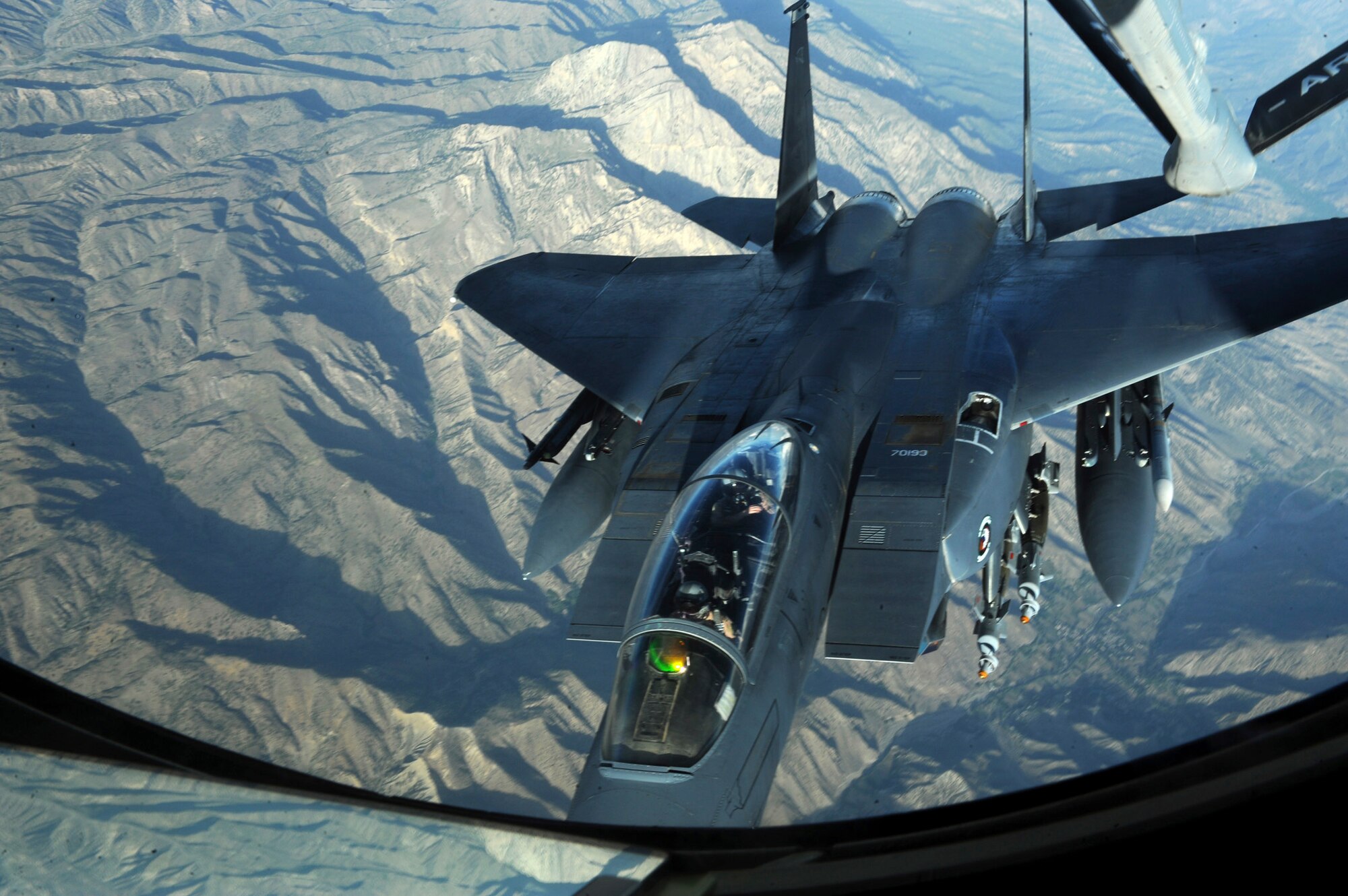OVER AFGHANISTAN - Capt. Steven Henderson and 1st Lt. Neil Mercer refuel their F-15E Strike Eagle on a mission over Eastern Afghanistan Aug. 2. Soon after the refueling, Captain Henderson and Lieutenant Mercer responded to a call for air support by troops in contact in the Nuristan Province. After a show of force flyover, the insurgents retreated from their attack on the forward operating base. Captain Henderson, the pilot, and Lieutenant Mercer, the weapon systems officer, are deployed from Seymour Johnson Air Force Base, N.C. (U.S. Air Force photo/Staff Sgt. J.G. Buzanowski)