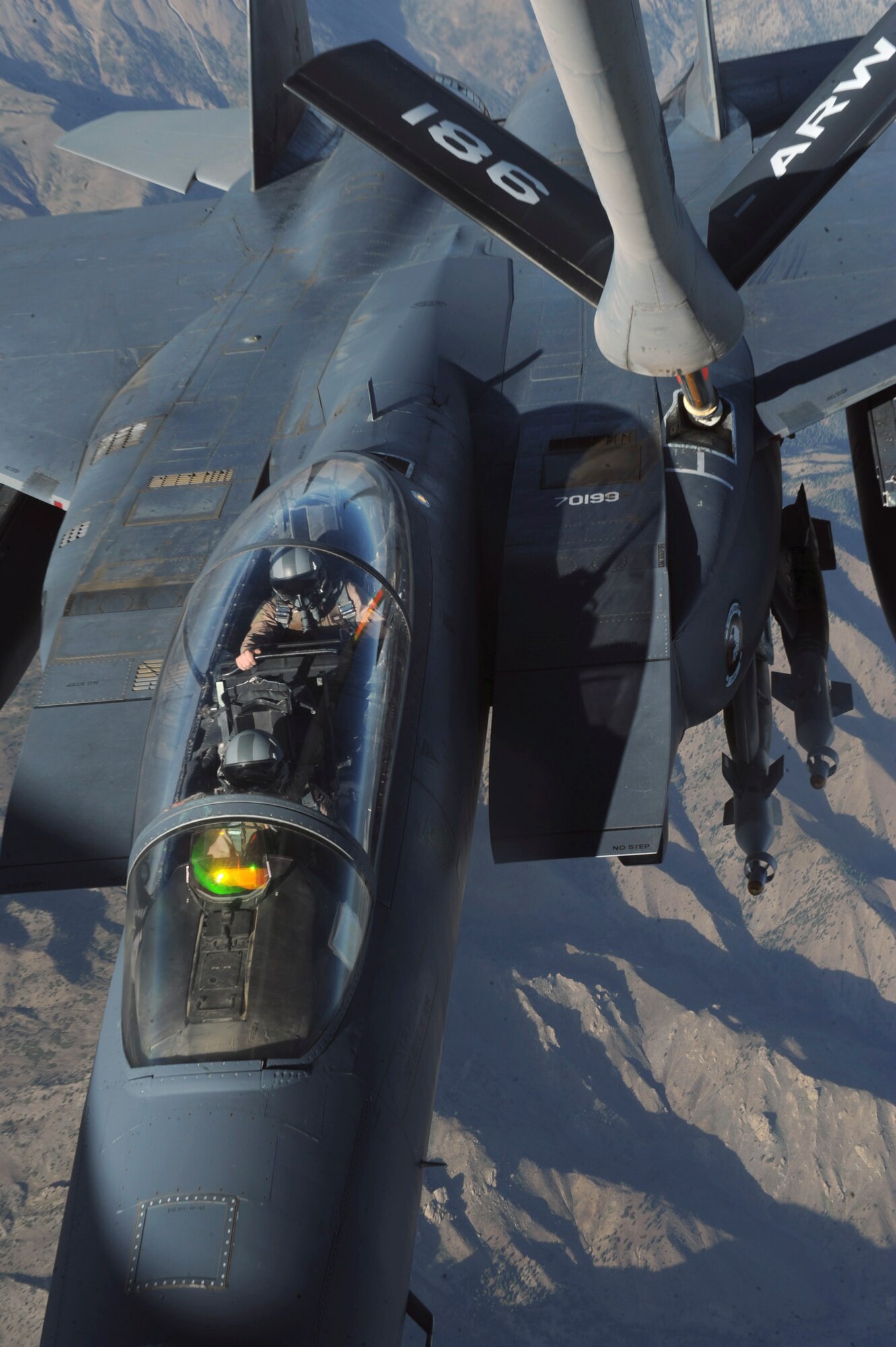 OVER AFGHANISTAN - Capt. Steven Henderson and 1st Lt. Neil Mercer refuel their F-15E Strike Eagle on a mission over Eastern Afghanistan Aug. 2. Soon after the refueling, Captain Henderson and Lieutenant Mercer responded to a call for air support by troops in contact in the Nuristan Province. After a show of force flyover, the insurgents retreated from their attack on the forward operating base. Captain Henderson, the pilot, and Lieutenant Mercer, the weapon systems officer, are deployed from Seymour Johnson Air Force Base, N.C. (U.S. Air Force photo/Staff Sgt. J.G. Buzanowski)