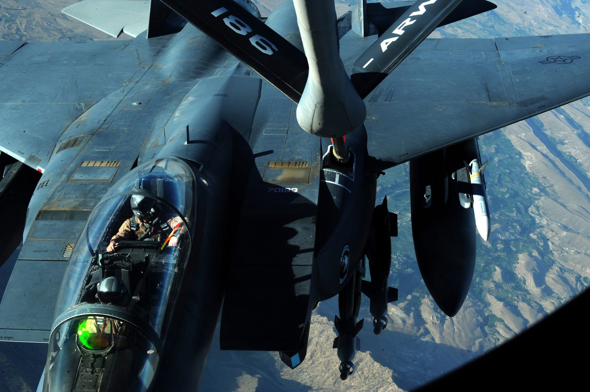 OVER AFGHANISTAN - Capt. Steven Henderson and 1st Lt. Neil Mercer refuel their F-15E Strike Eagle on a mission over Eastern Afghanistan Aug. 2. Soon after the refueling, Captain Henderson and Lieutenant Mercer responded to a call for air support by troops in contact in the Nuristan Province. After a show of force flyover, the insurgents retreated from their attack on the forward operating base. Captain Henderson, the pilot, and Lieutenant Mercer, the weapon systems officer, are deployed from Seymour Johnson Air Force Base, N.C. (U.S. Air Force photo/Staff Sgt. J.G. Buzanowski)