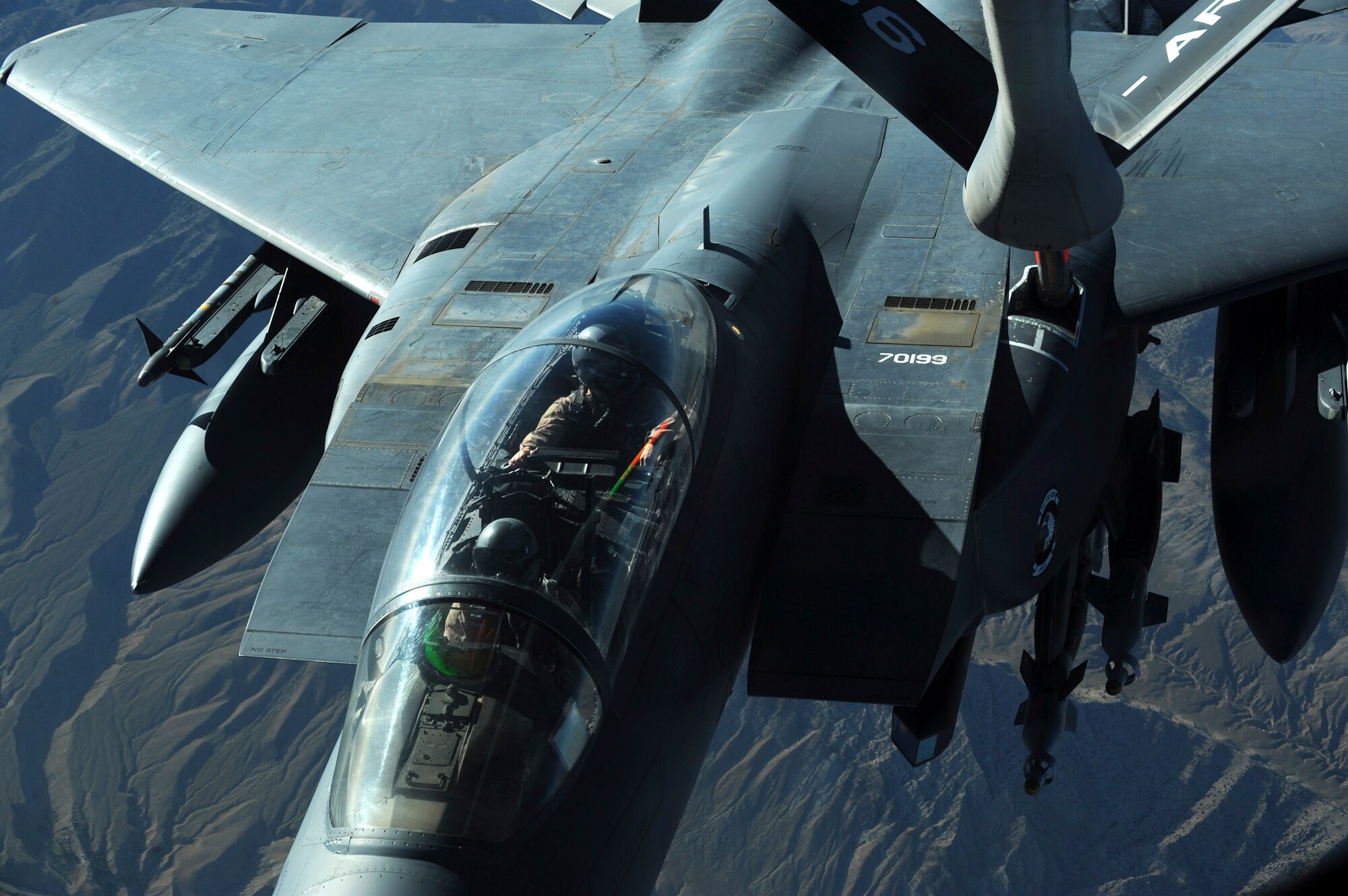 OVER AFGHANISTAN - Capt. Steven Henderson and 1st Lt. Neil Mercer refuel their F-15E Strike Eagle on a mission over Eastern Afghanistan Aug. 2. Soon after the refueling, Captain Henderson and Lieutenant Mercer responded to a call for air support by troops in contact in the Nuristan Province. After a show of force flyover, the insurgents retreated from their attack on the forward operating base. Captain Henderson, the pilot, and Lieutenant Mercer, the weapon systems officer, are deployed from Seymour Johnson Air Force Base, N.C. (U.S. Air Force photo/Staff Sgt. J.G. Buzanowski)