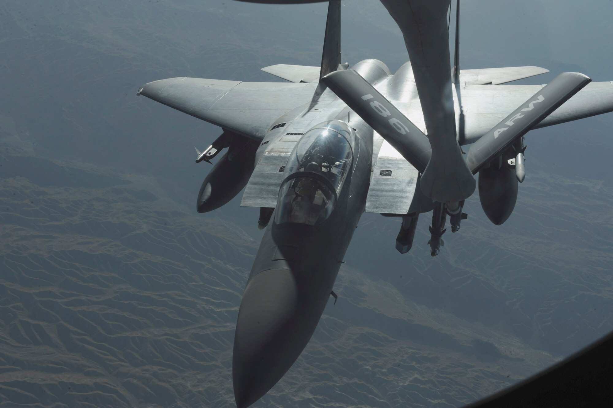 OVER AFGHANISTAN - Capt. Steven Henderson and 1st Lt. Neil Mercer refuel their F-15E Strike Eagle on a mission over Eastern Afghanistan Aug. 2. Soon after the refueling, Captain Henderson and Lieutenant Mercer responded to a call for air support by troops in contact in the Nuristan Province. After a show of force flyover, the insurgents retreated from their attack on the forward operating base. Captain Henderson, the pilot, and Lieutenant Mercer, the weapon systems officer, are deployed from Seymour Johnson Air Force Base, N.C. (U.S. Air Force photo/ Staff Sgt. J.G. Buzanowski)