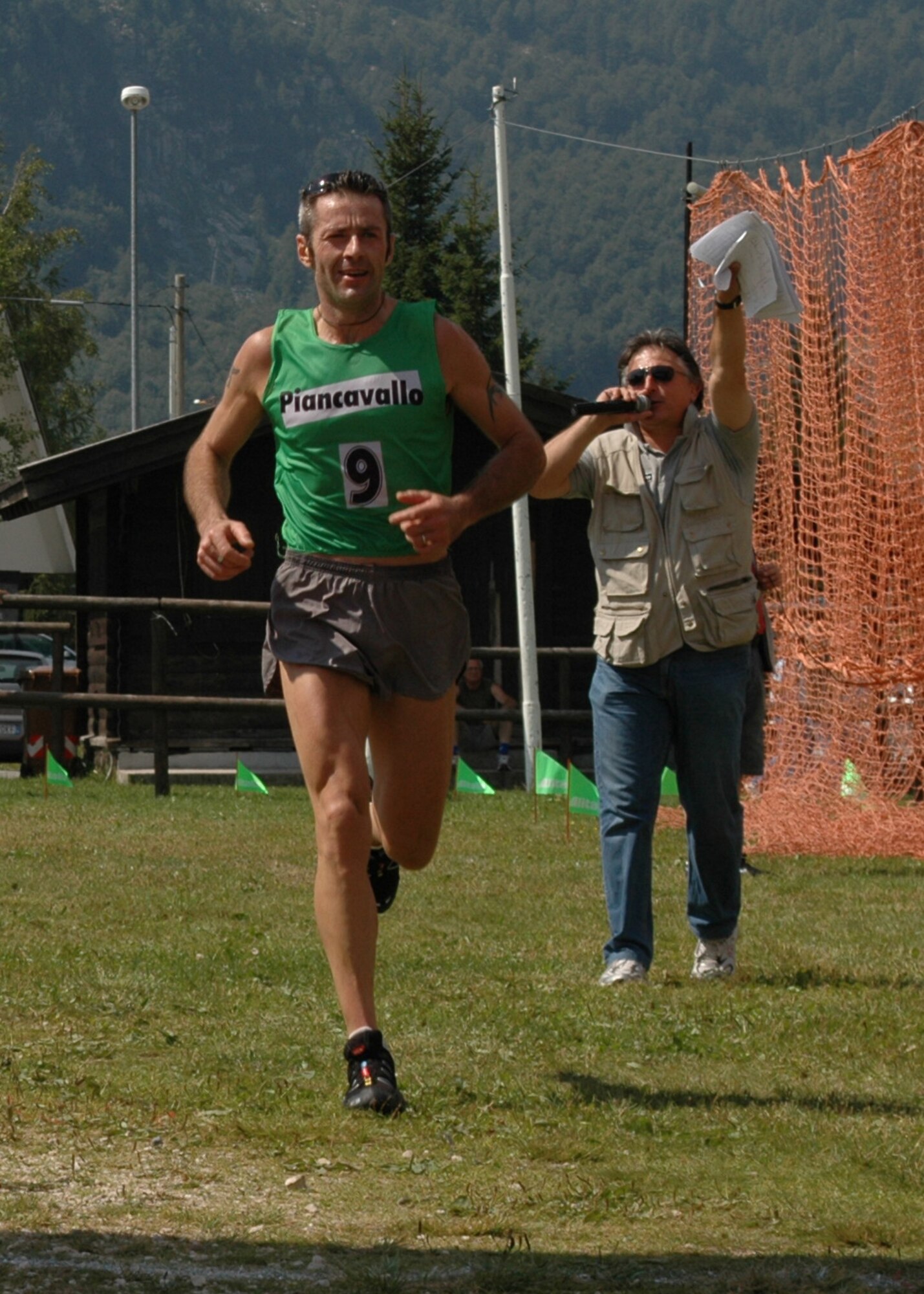 Michele Ermacora, 42, finished the third and final leg of a mountainous 7-kilometer race at Piancavallo, Italy, Aug. 2, 2009, in 33 minutes and 29 seconds.  Mr. Ermacora’s A.N.A. Cordovado teammates Enzo Versolato, 46, and Luca Bardoni, 47, ran the first and second leg respectively and took first place with a combined team time of 1:46:47.  The annual event is hosted by the Alpini alumni association.  (U.S. Air Force photo/Tech. Sgt. Michael O’Connor)