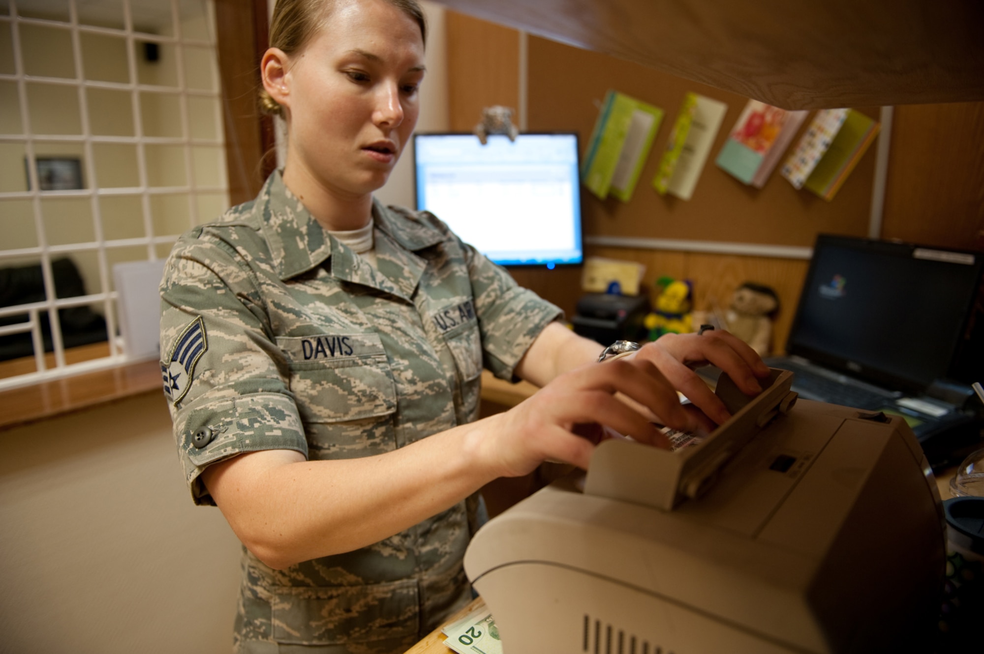 Senior Airman Teresa Davis, 379th Air Expeditionary Wing finance customer service technician cashier, counts U.S. currency for a service member deployed to Southwest Asia, Aug. 4. The finance office assists military members with issues involving their pay, entitlements and benefits and has the ability to exchange global currencies. Airman Davis is a native of Dauphin Island, Ala. and is deployed from Little Rock Air Force Base, Ark., in support of Operations Iraqi and Enduring Freedom. (U.S. Air Force Photo/Staff Sgt. Robert Barney)
