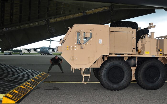 CHARLESTON AIR FORCE BASE, S.C. - Tech. Sgt. Andrew Cavanaugh supervises the loading of a Mine Resistant Ambush Protected vehicle July 31 at Charleston AFB, S.C., onto a C-5 Galaxy assigned to the 337th Airlift Squadron, located in Westover, Mass. The MRAP vehicle is a next-generation armored truck and was transported to a deployed location in Southwest Asia. Sergeant Cavanaugh is a loadmaster with the 337th AS. (U.S. Air Force photo/Staff Sgt. Daniel Bowles)