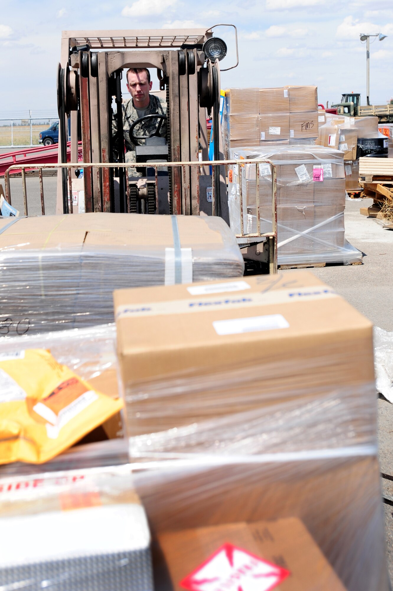 TRANSIT CENTER AT MANAS, Kyrgyzstan -- Airman 1st Class Ivan Hurd, 376th Expeditionary Logistics Readiness Squadron supply warehouse journeyman, prepares to transport products with a forklift at the Transit Center at Manas. Supply picks up shipments ordered in to the transportation management office on a daily basis. Airman Hurd is deployed from the 100th LRS at the Royal Air Force Mildenhall, U.K. and is originally from Libby, Mont. (U.S. Air Force photo/Senior Airman Steele C. G. Britton)