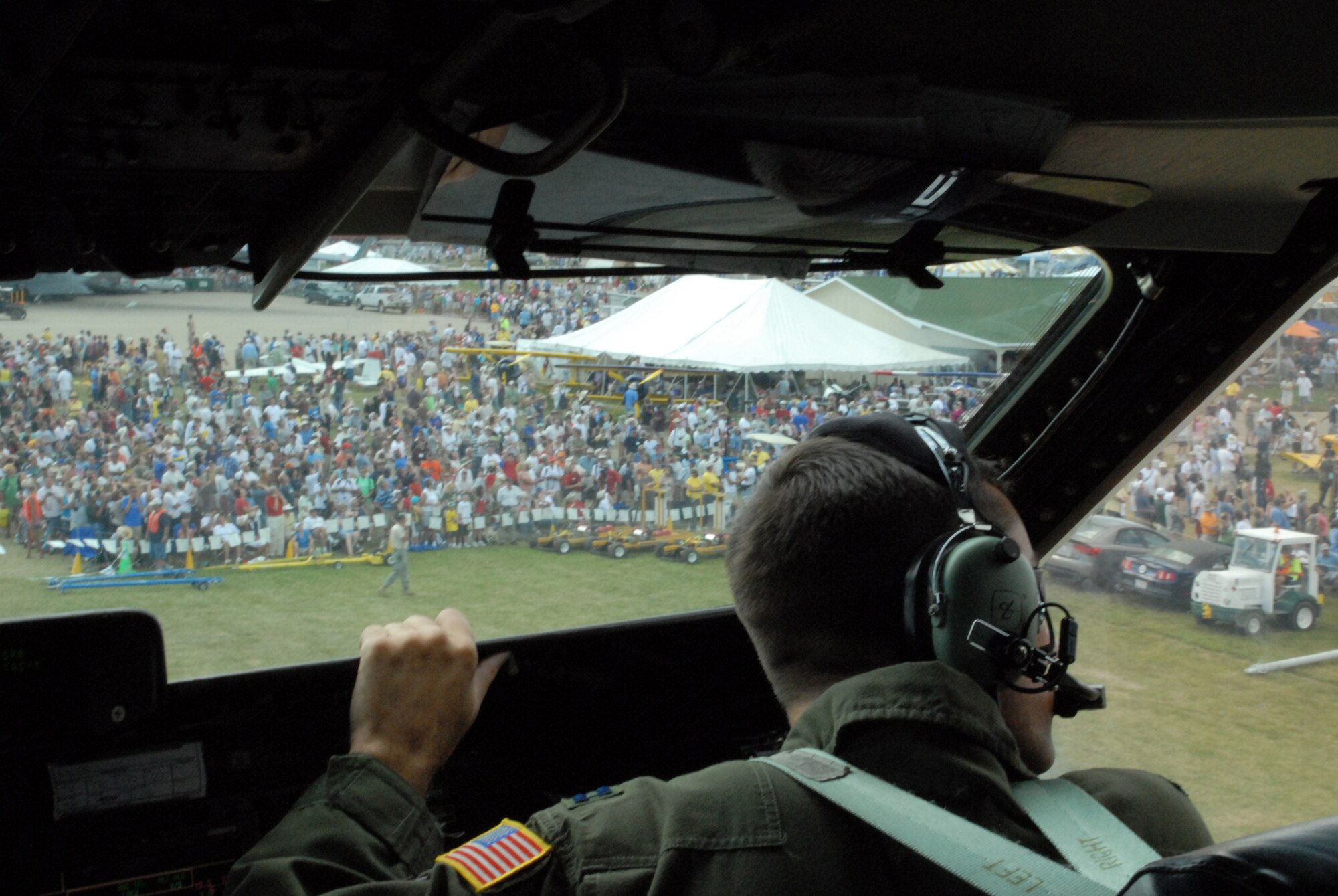 Capt Cory Damon, 9th Airlift Squadron pilot, helps taxi in a Dover C-5M Super Galaxy to the EAA AirVenture Oshkosh.  The C-5M was visited by more than 10,000 visitors during its two-days of display at the event.  (U.S. Air Force photo/Staff Sgt. Chad Padgett) 