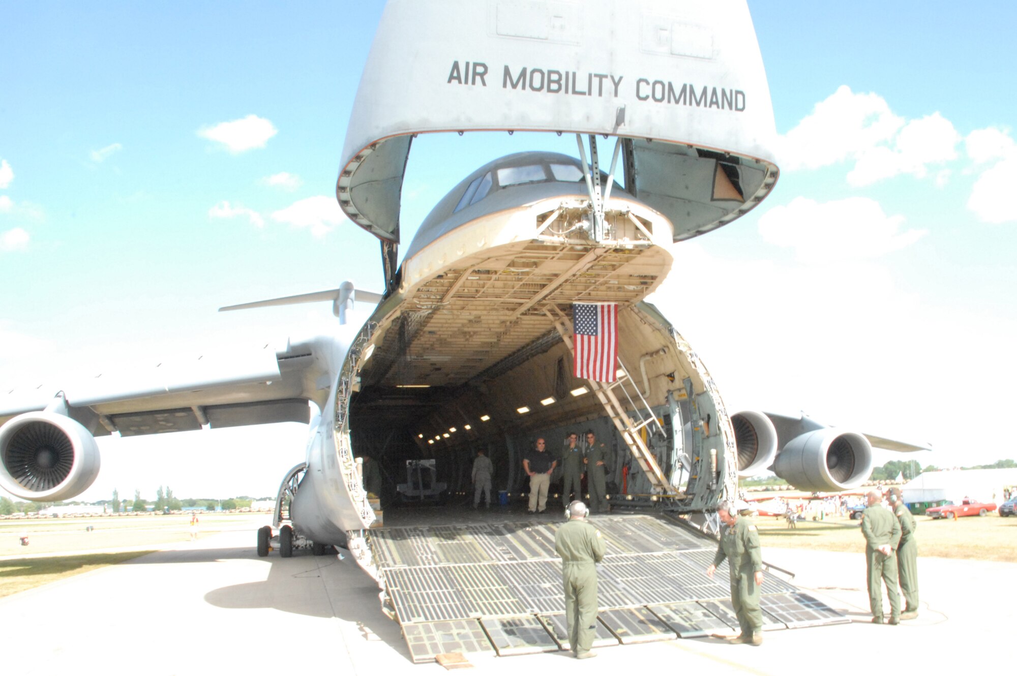 Crewmembers make final checks of the C-5M Super Galaxy The Spirit of Normandy, at EAA AirVenture Oshkosh.  More than 10,000 guests toured the aircraft during The Spirit of Normandy?s two-day visit to the event.  (U.S. Air Force photo/Staff Sgt. Chad Padgett)