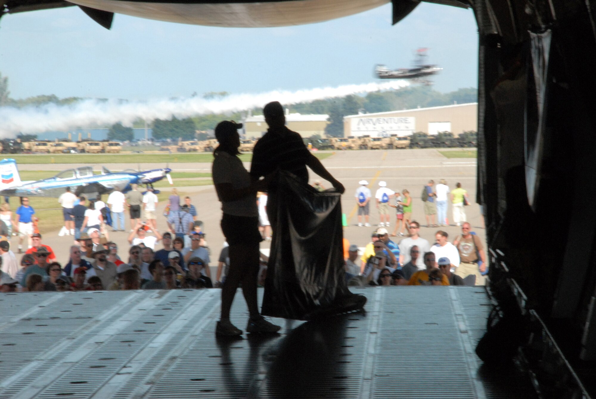 Representatives from Lockheed-Martin prepare the C-5M Super Galaxy for visitors during the EAA AirVenture Oshkosh.  More than 10,000 guests toured the aircraft during The Spirit of Normandy?s two-day visit to the event.  (U.S. Air Force photo/Staff Sgt. Chad Padgett)