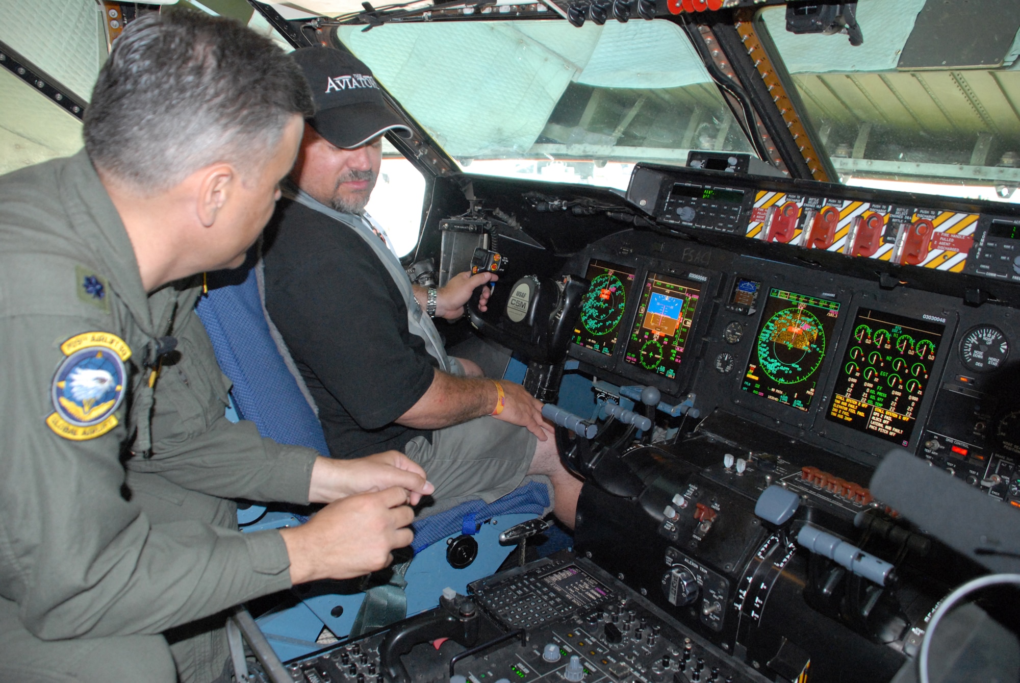 Lt. Col. Mike Semo, 709th Airlift Squadron pilot, gives a tour of the C-5M Super Galaxy to a media member during EAA AirVenture Oshkosh in Wisconsin.  More than 10,000 guests toured the aircraft during The Spirit of Normandy?s two-day visit to the event.  (U.S. Air Force photo/Staff Sgt. Chad Padgett)