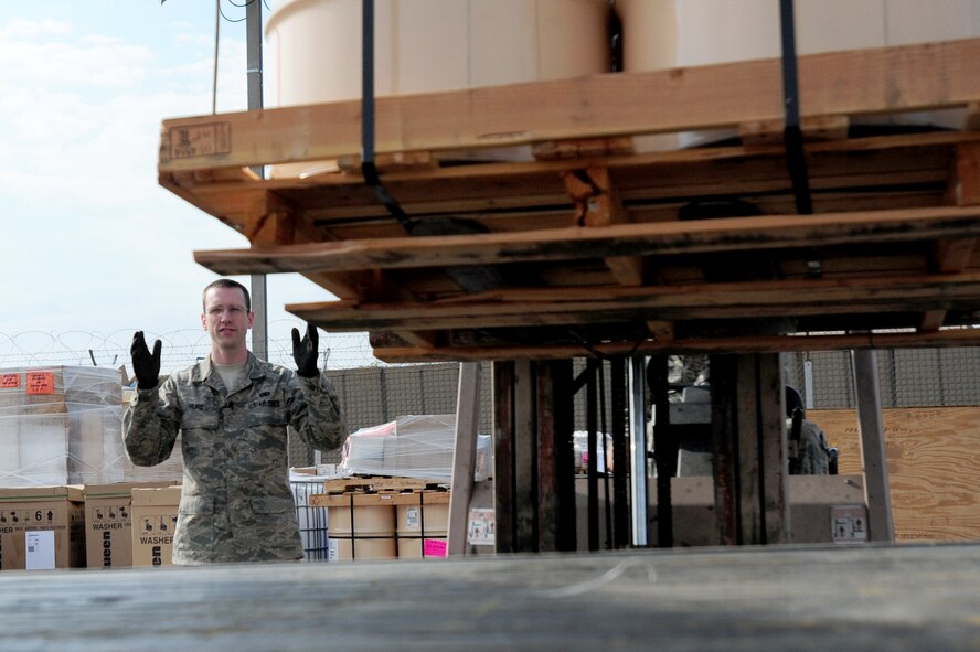 TRANSIT CENTER AT MANAS, Kyrgyzstan -- Airman 1st Class Ivan Hurd, 376th Expeditionary Logistics Readiness Squadron supply warehouse journeyman, ensures a pallet is safely loaded at the Transit Center at Manas, recently. Supply Airmen keep safety in mind while working with heavy products on a daily basis. Airman Hurd is deployed from the 100th LRS at the Royal Air Force Mildenhall, U.K. and is originally from Libby, Mont. (U.S. Air Force photo/Senior Airman Steele C. G. Britton)