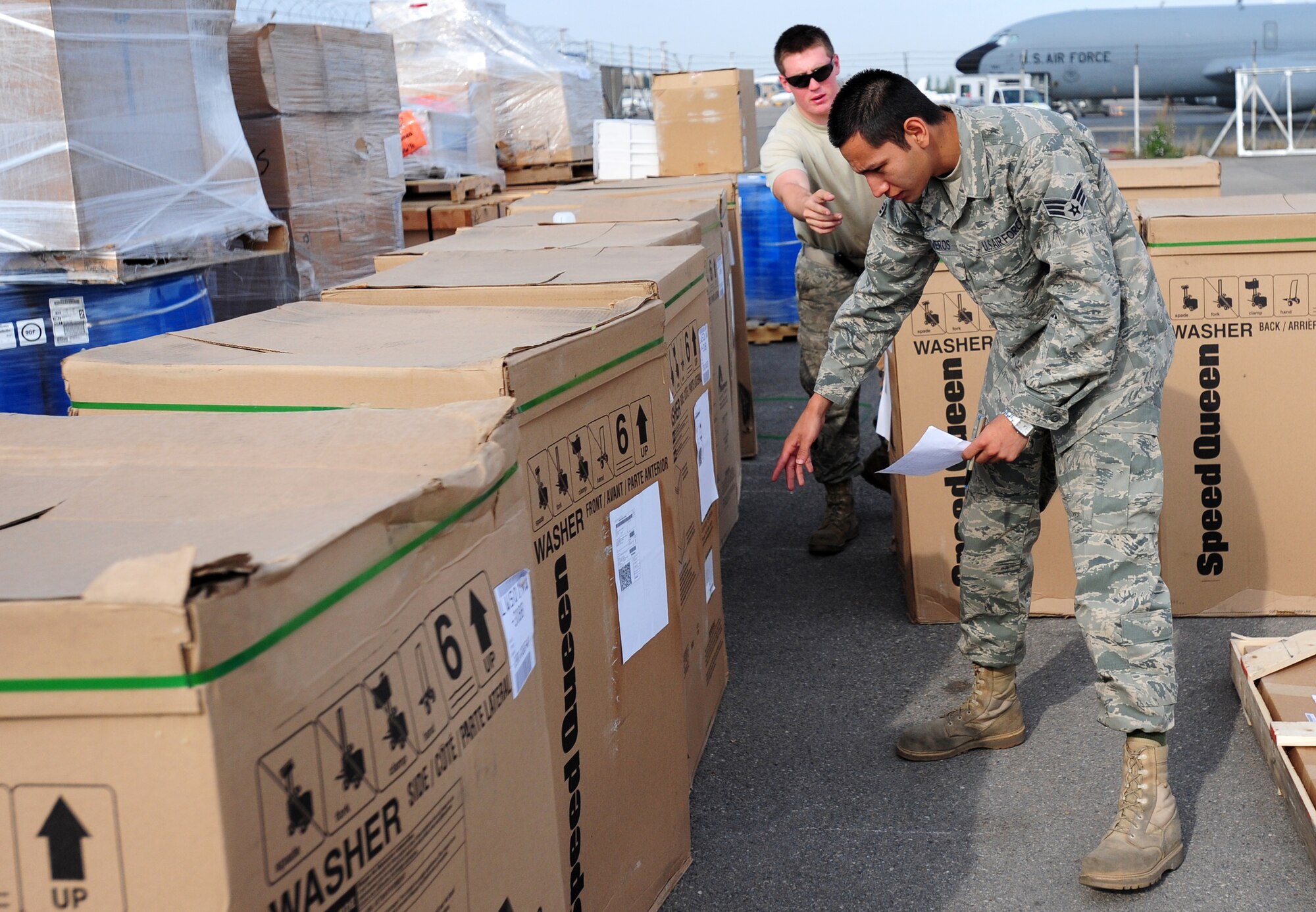 TRANSIT CENTER AT MANAS, Kyrgyzstan -- Senior Airman Jorge Ontiveros and Airman 1st Class Joshua Lee, 376th Expeditionary Logistics Readiness Squadron journeymen, work together to verify shipment numbers on products at the Transit Center at Manas. Ensuring correct products are delivered to the customer is a key first step in supply. Senior Airman Ontiveros is deployed from the 100th LRS at the Royal Air Force Mildenhall, U.K. and is originally from El Paso, Texas. Airman Lee is deployed from the 366th LRS at Mountain Home Air Force Base, Idaho and is originally from Ashboro, N.C. (U.S. Air Force photo/Senior Airman Steele C. G. Britton)